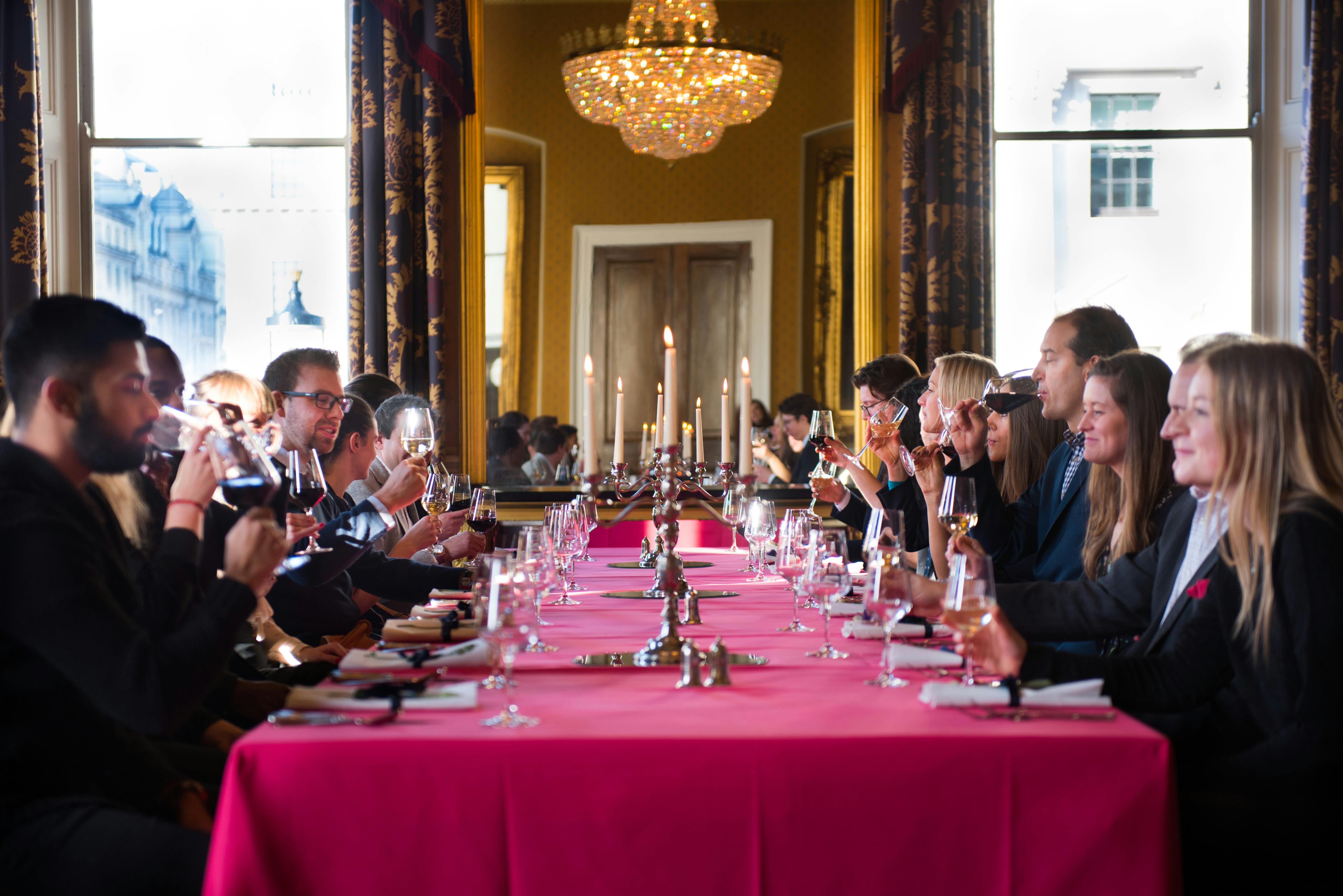 Elegant corporate event dining setup at Waterloo, featuring pink linens and candlelight.
