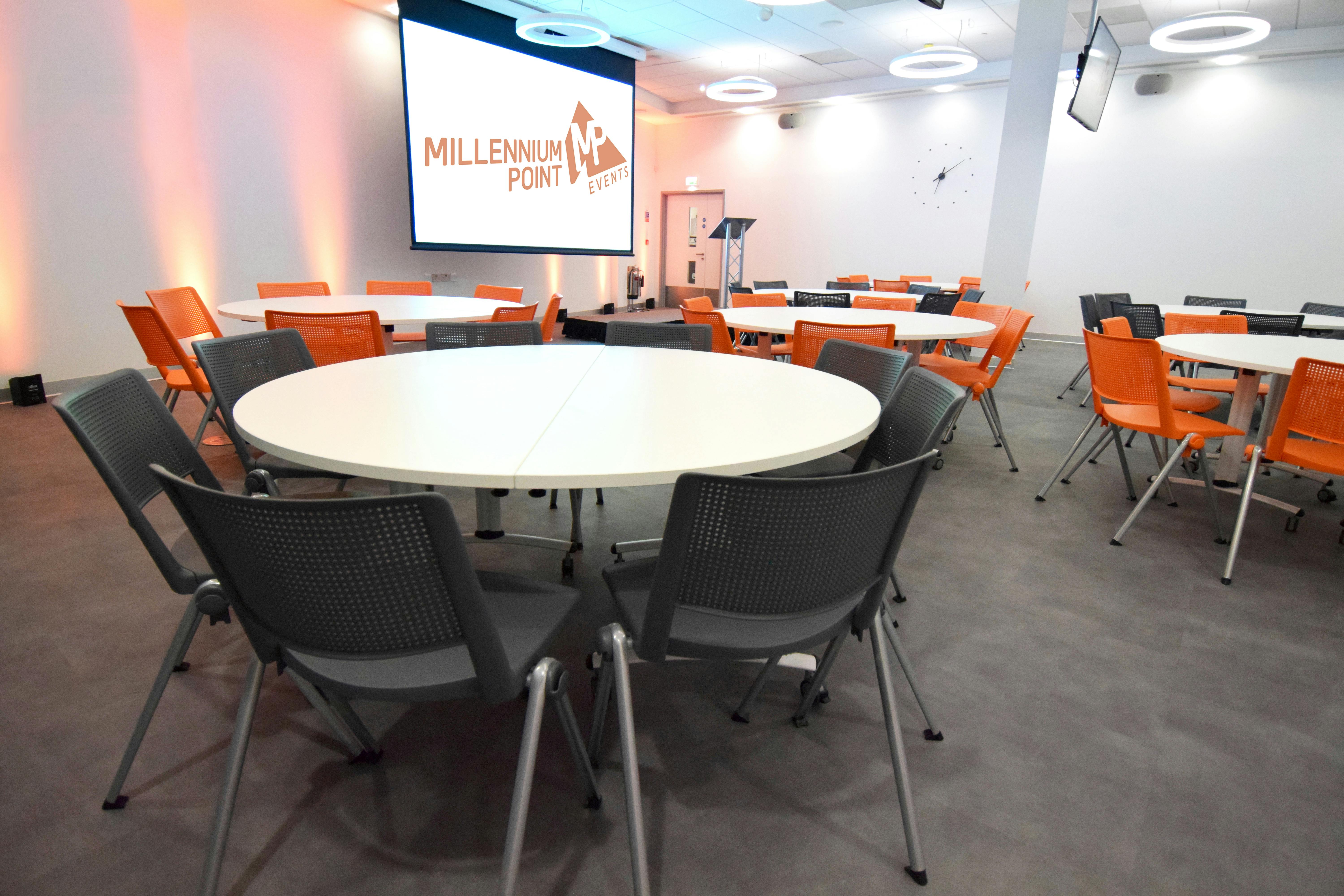 CONNECT Event Space with round tables, ideal for meetings and presentations.