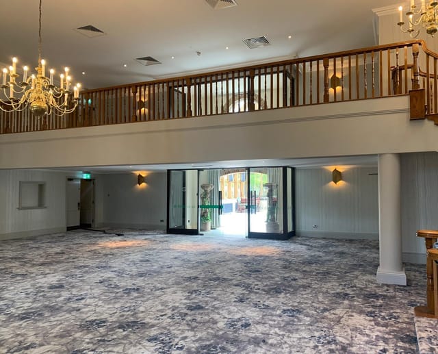 Elegant Garden Court venue with chandelier, ideal for corporate events and celebrations.