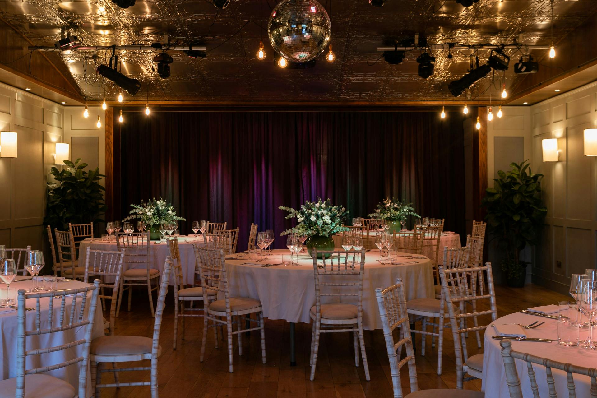 Elegant Green Room at Century Club with floral centerpieces for weddings and corporate events.