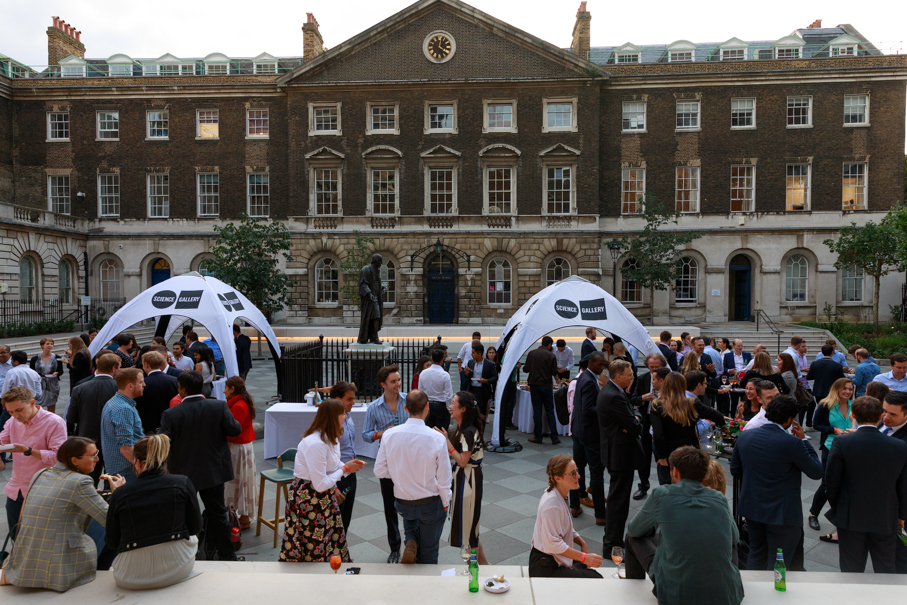 Outdoor networking event at Science Gallery London under white canopies, fostering connections.