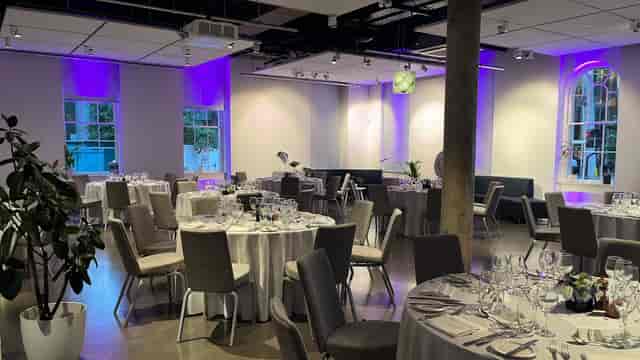 Ground Floor Space at Science Gallery London, elegant dinner setup with purple lighting.