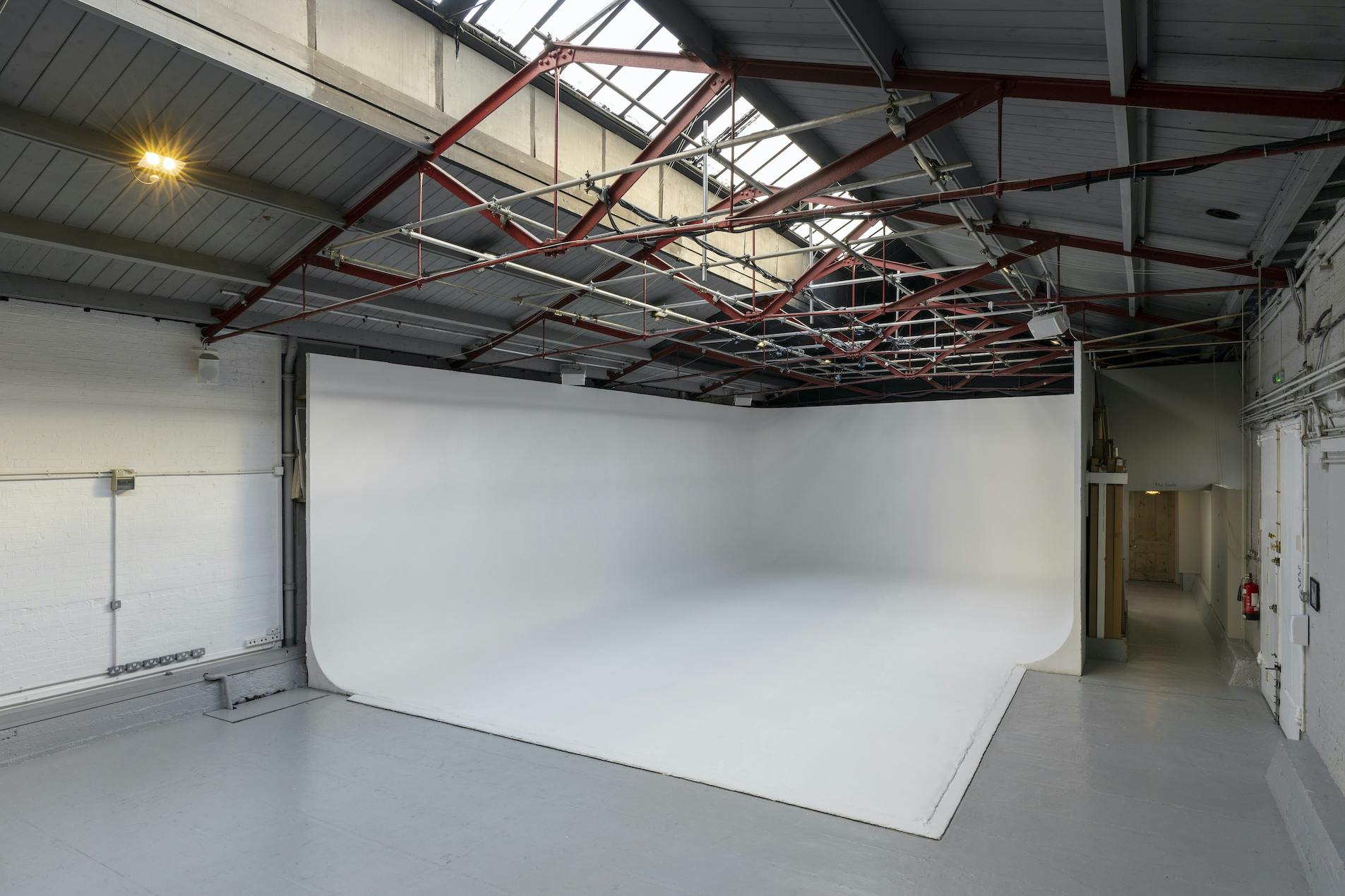 Versatile event space in Park Village with a large white backdrop for meetings and photo shoots.