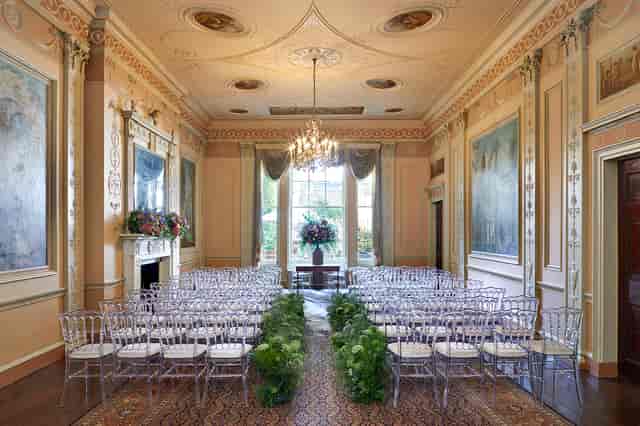 Elegant event space with chiavari chairs and floral centerpiece for upscale gatherings.