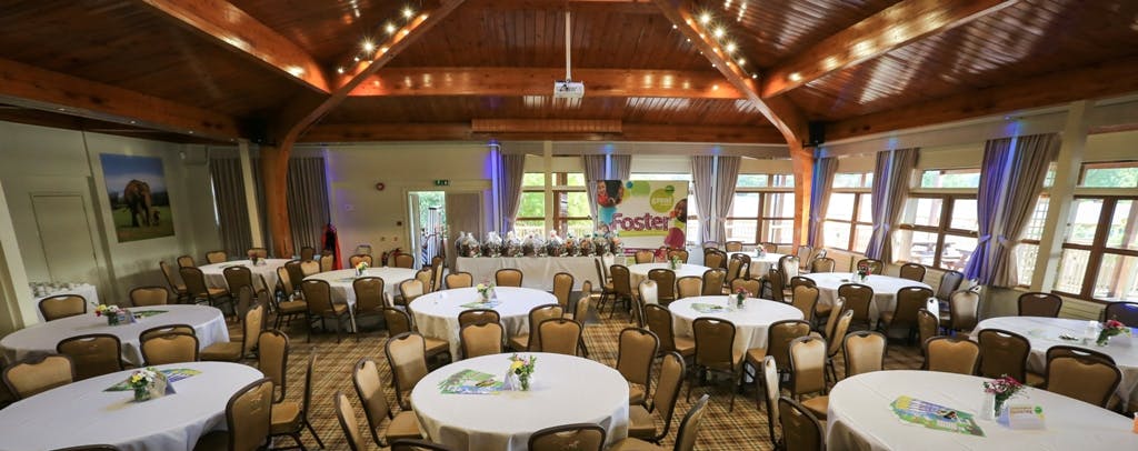 Spacious Woburn Safari Lodge event venue with round tables for meetings and banquets.