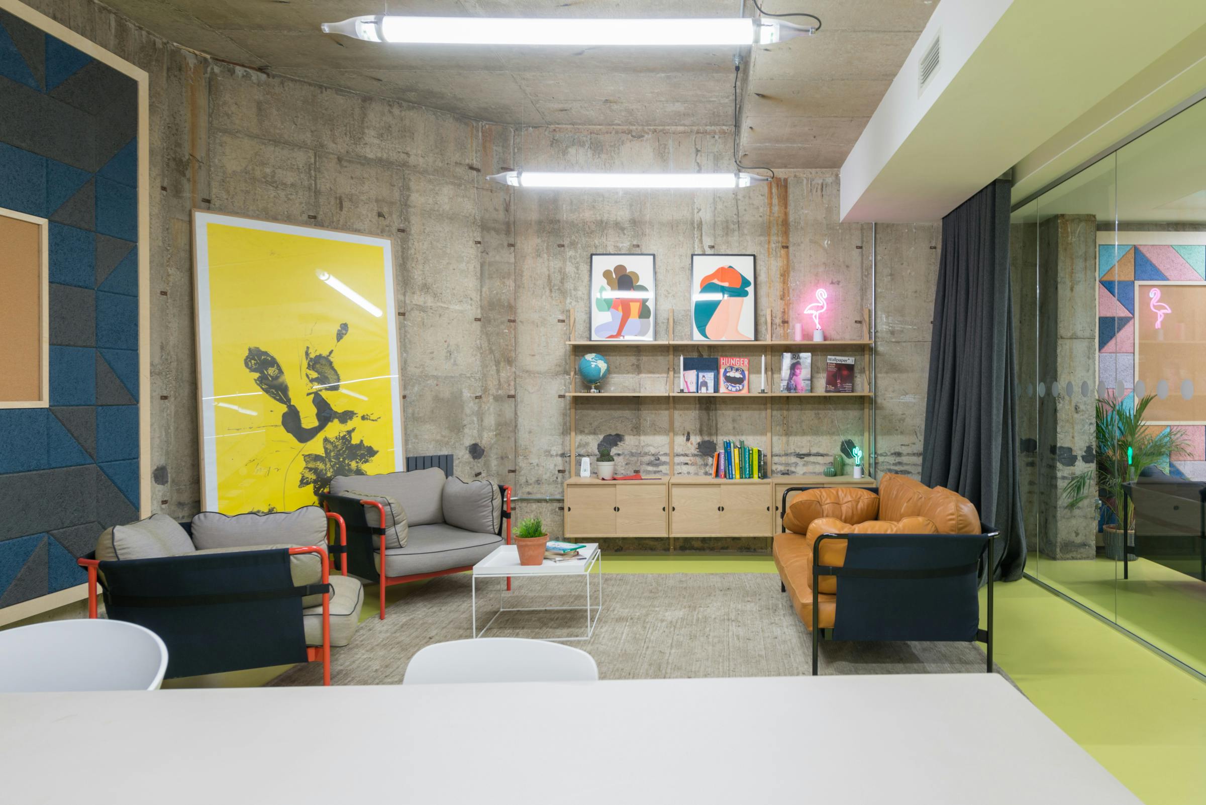 Modern meeting room with vibrant artwork, perfect for brainstorming sessions.