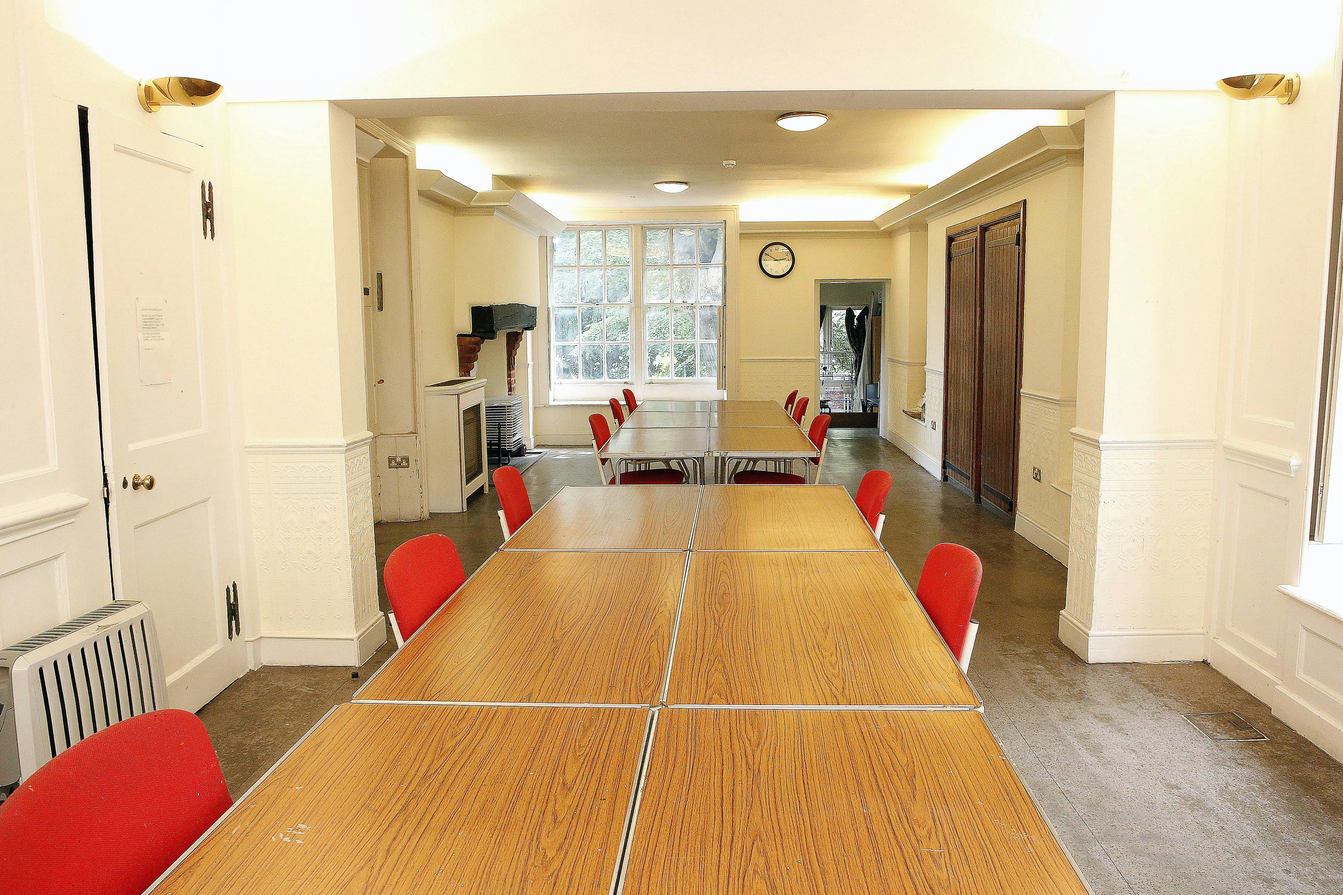 Ground Floor Salisbury Room with long table and red chairs, ideal for meetings and workshops.