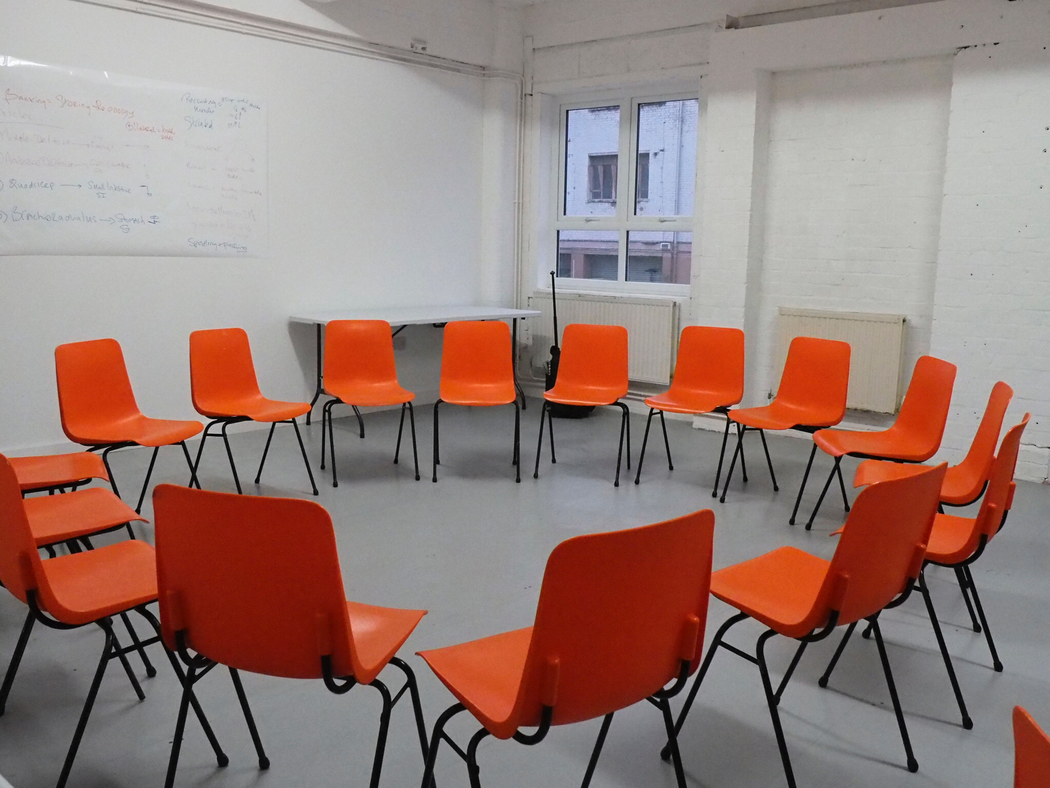 Whole Venue at Wick Lane Studio with circular orange chairs for workshops and collaboration.