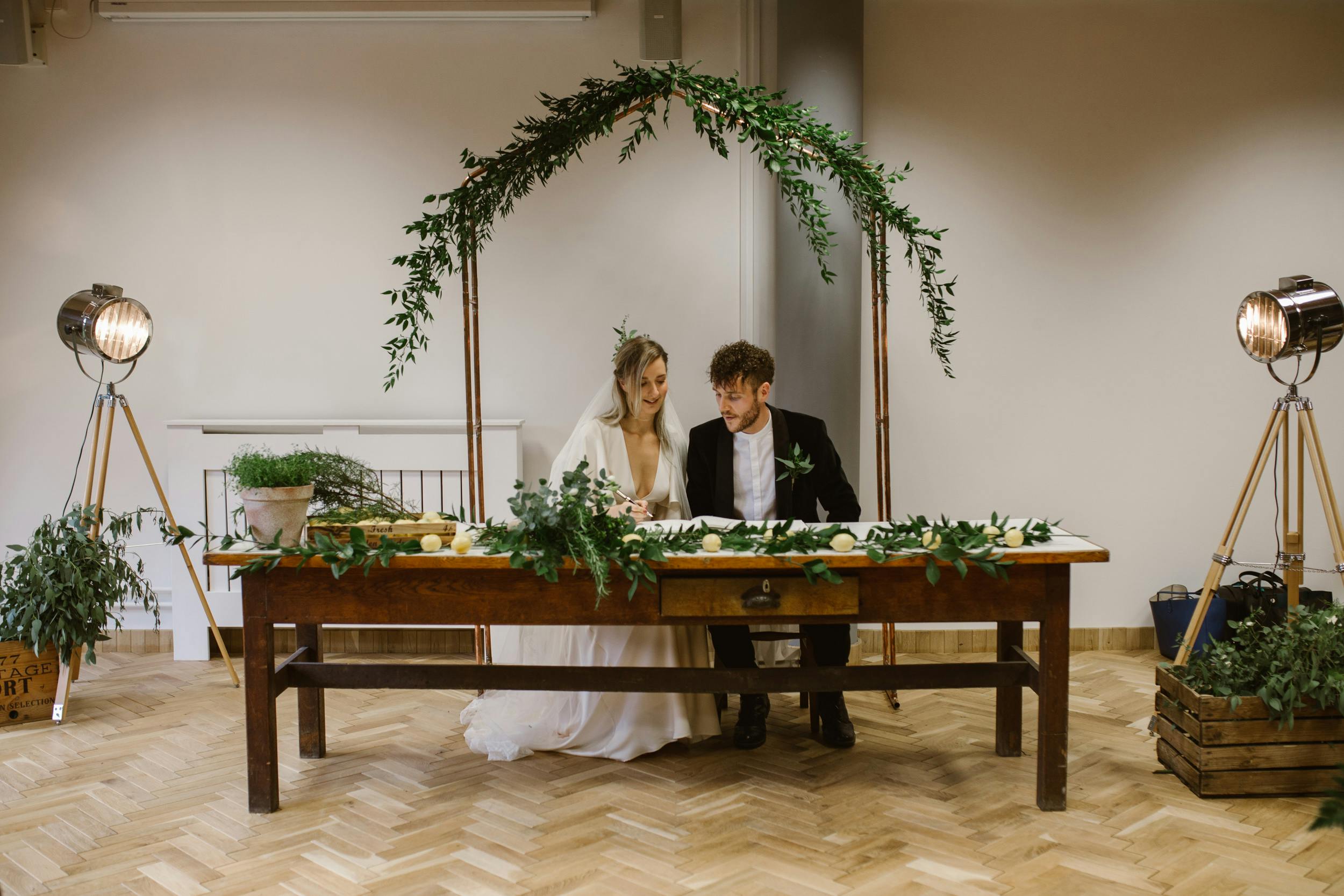 Elegant wedding setup in The Ollerton Room with lush greenery and rustic charm.