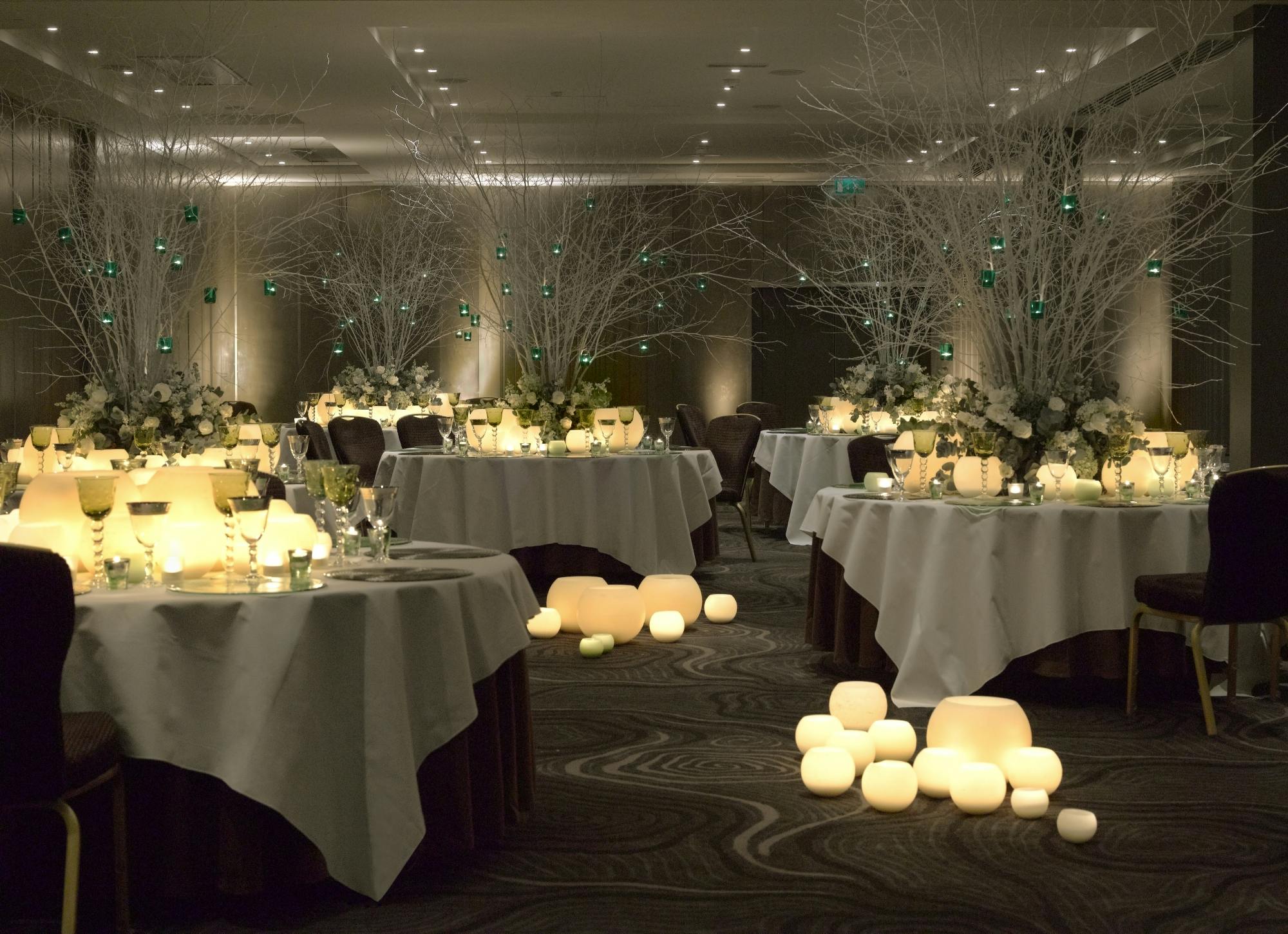 Elegant event space at Radisson Blu London with round tables and soft lighting.