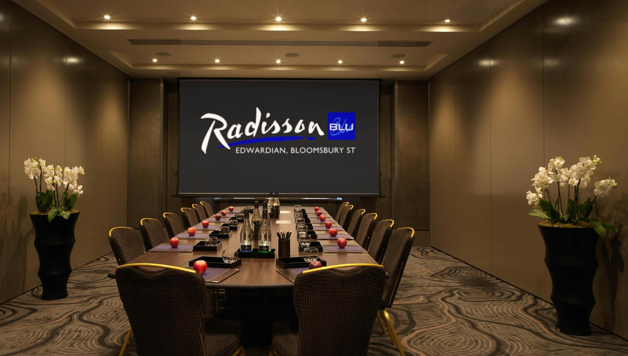 Private Room 2 at Radisson Blu, London: elegant meeting space with large screen for corporate events.