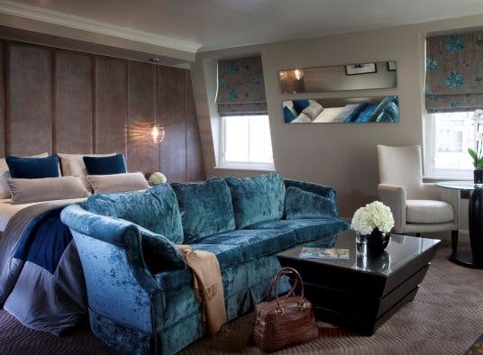 Private Room 4 at Radisson Blu London: stylish suite for meetings, featuring plush blue sofa.