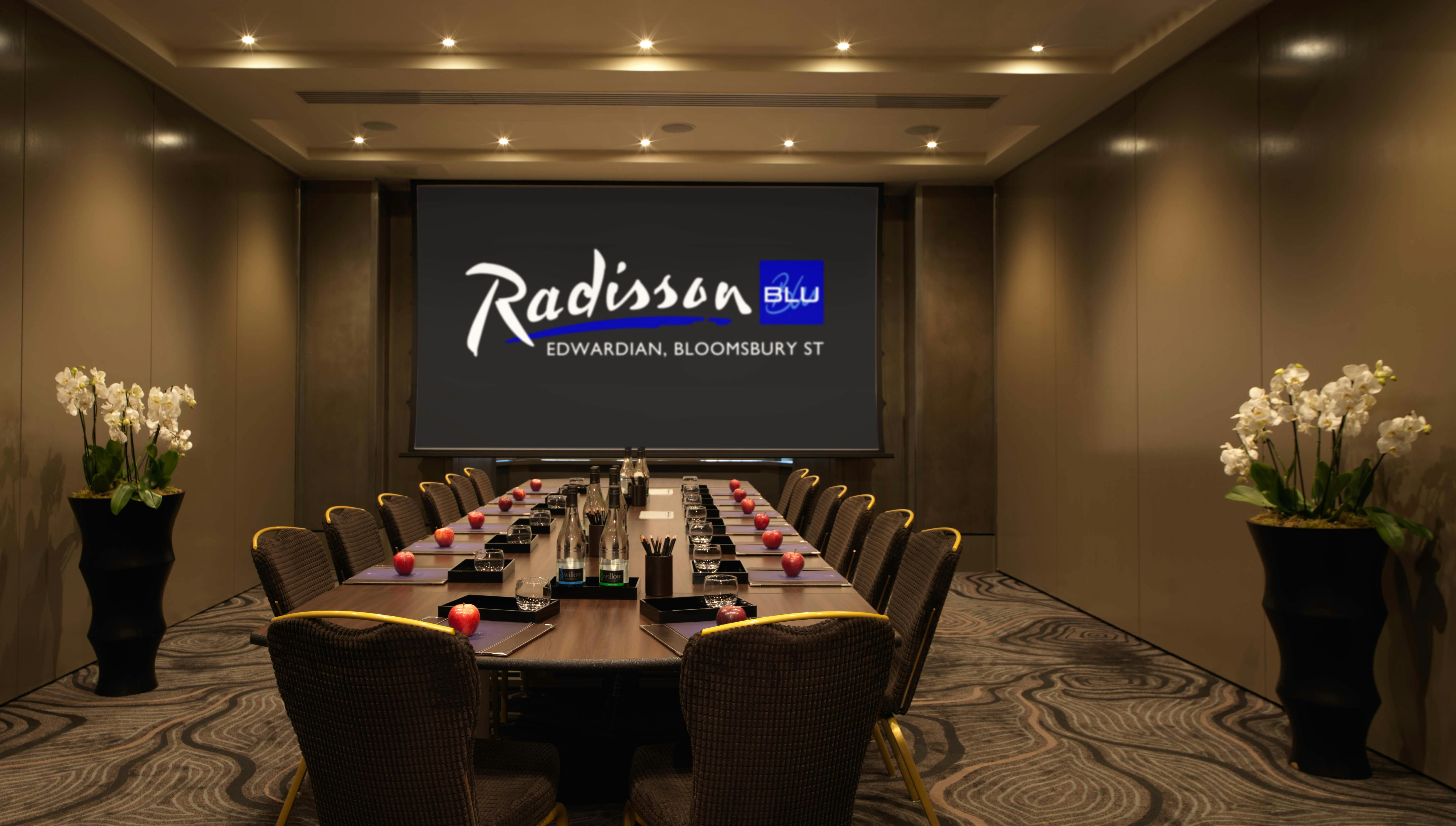 Modern meeting room with conference table at Radisson Blu, ideal for corporate events.