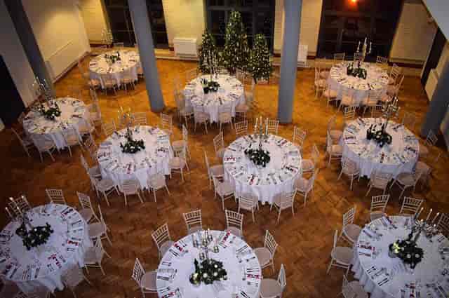 Elegant event space with round tables, ideal for holiday celebrations and formal gatherings.