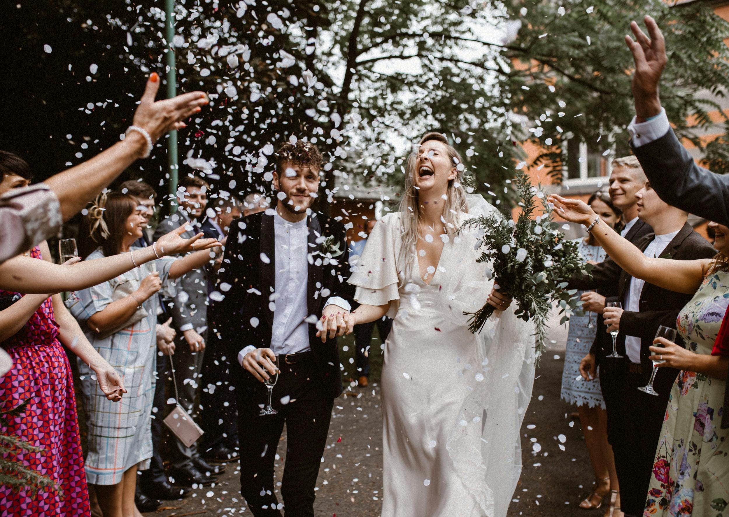 Joyful wedding celebration at The Pumping House with confetti and elegant decor.