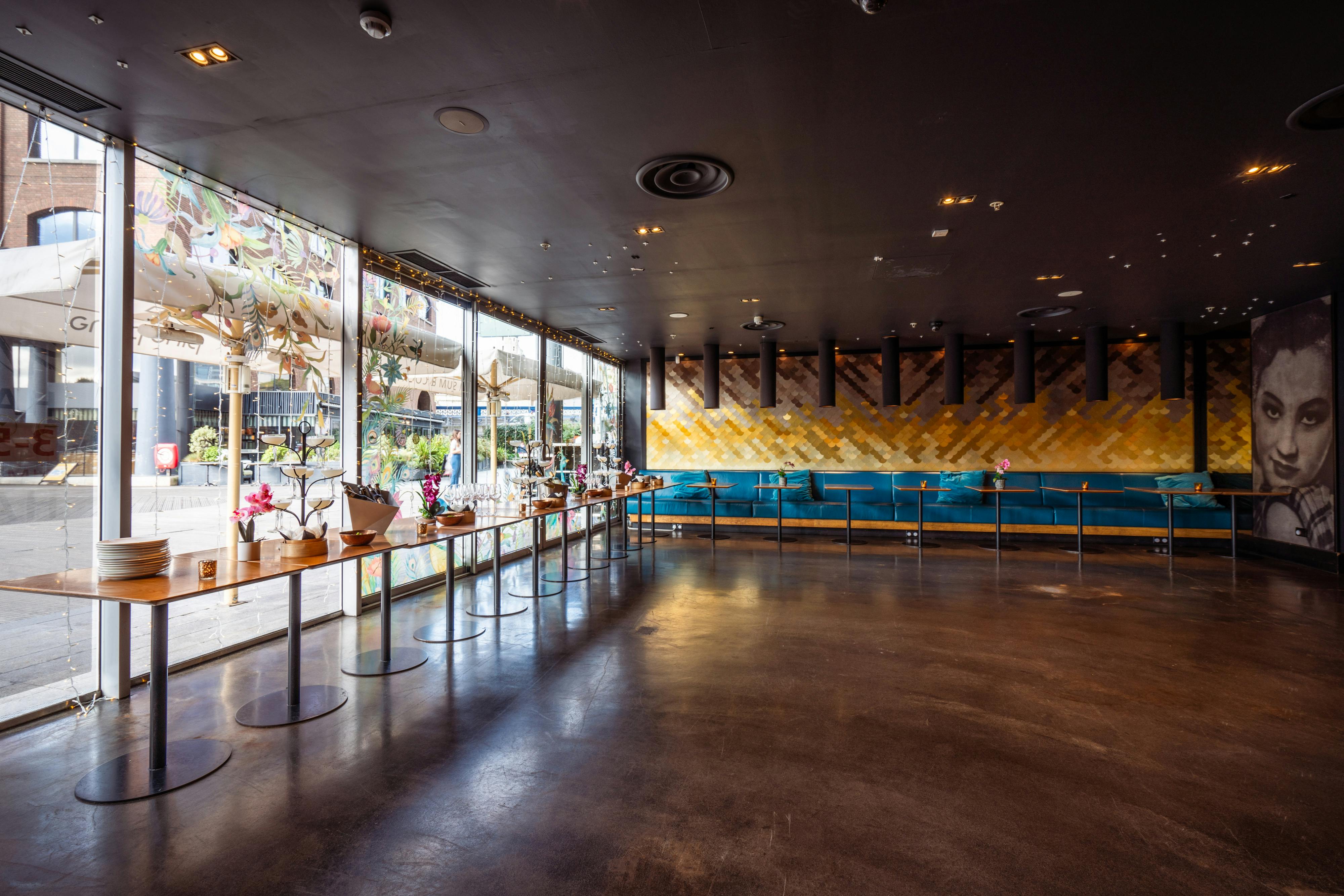 Modern event space with large windows at Ping Pong St Katherine Dock for receptions and networking.