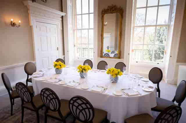 Elegant dining table with yellow flowers in Bennet-Clark Room for upscale events.
