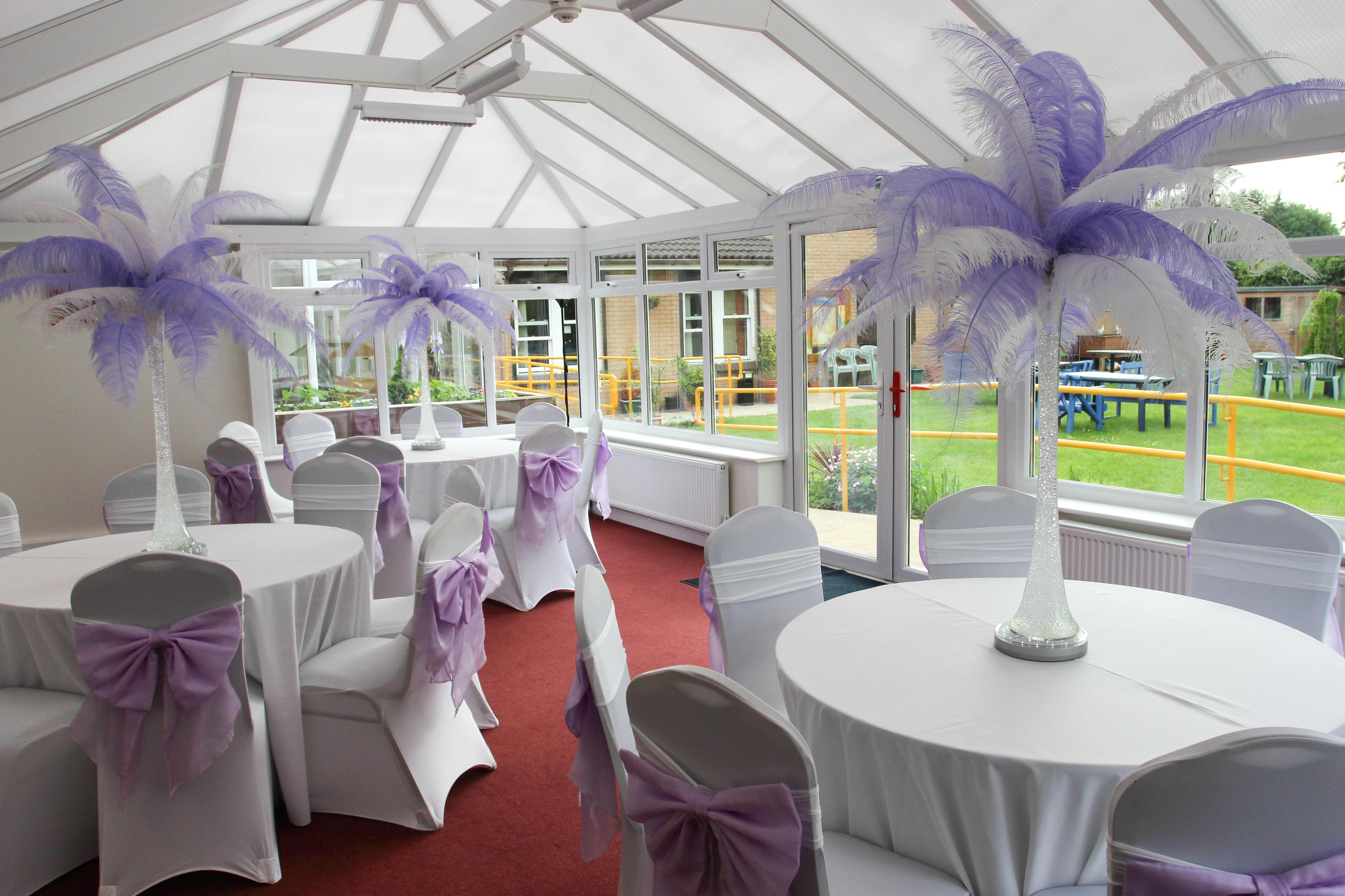 Iris Conservatory event space with elegant feather centerpieces, perfect for weddings.