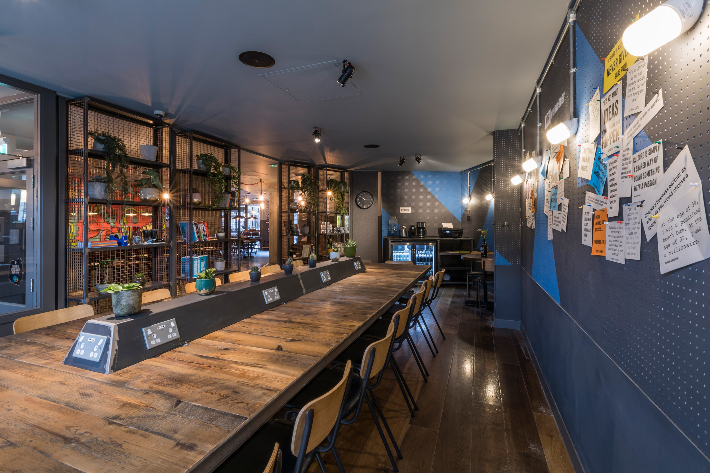 Modern semi-private meeting space with wooden table for workshops at BrewDog Paddington.