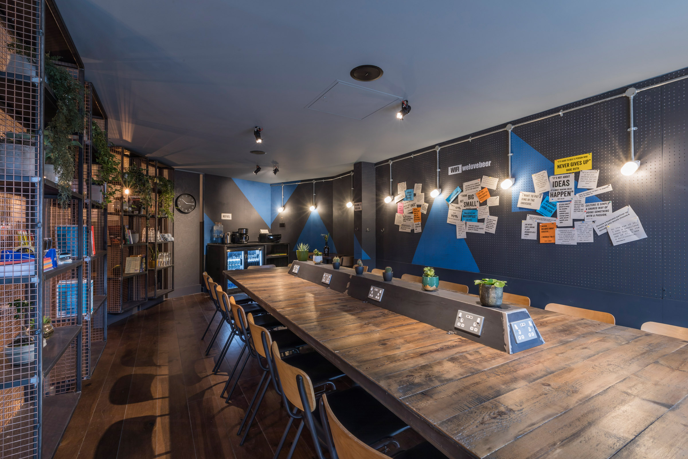 Modern semi-private meeting space with wooden table for workshops and brainstorming.