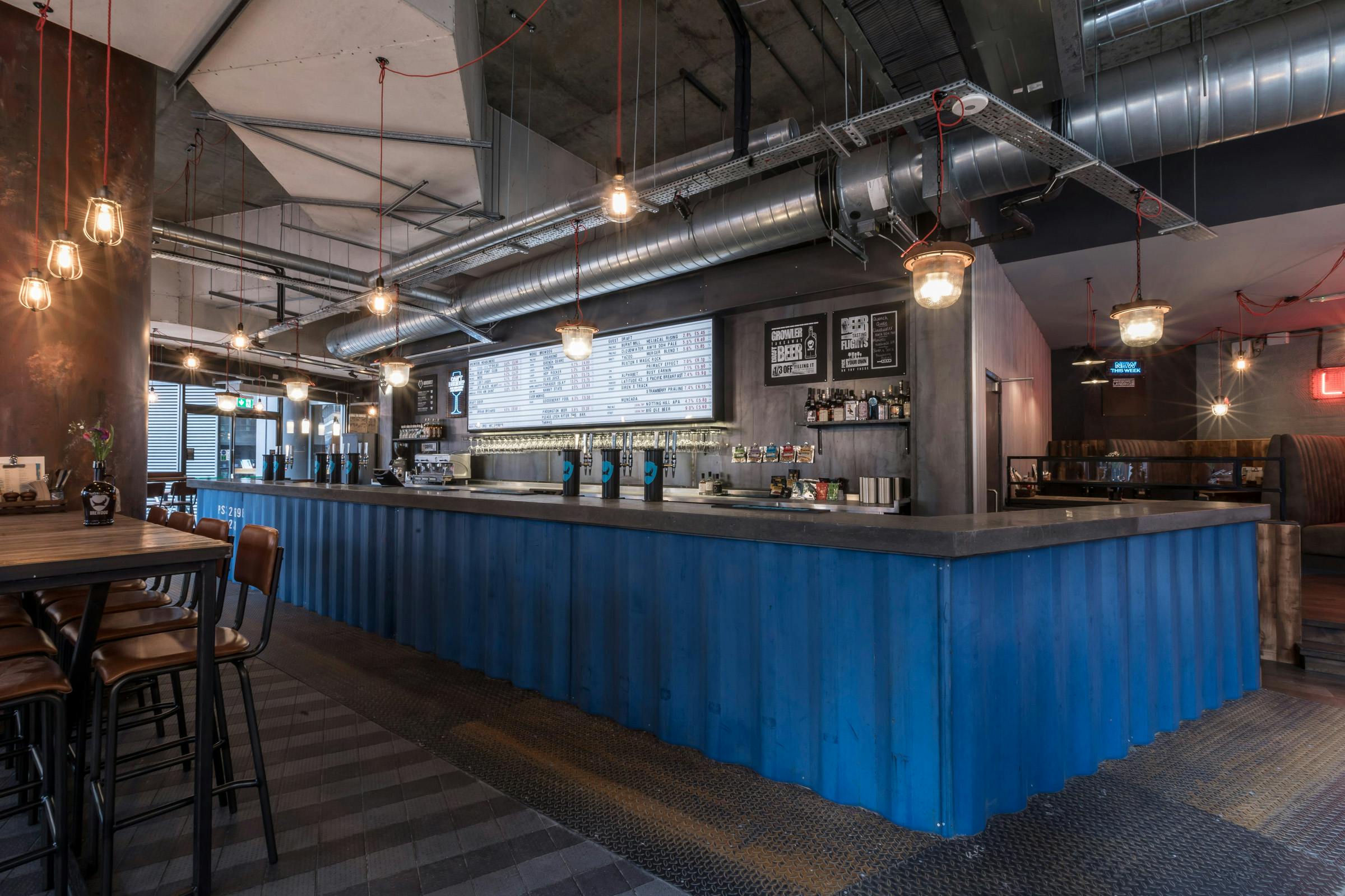 Modern industrial bar at BrewDog Paddington, ideal for networking events and gatherings.