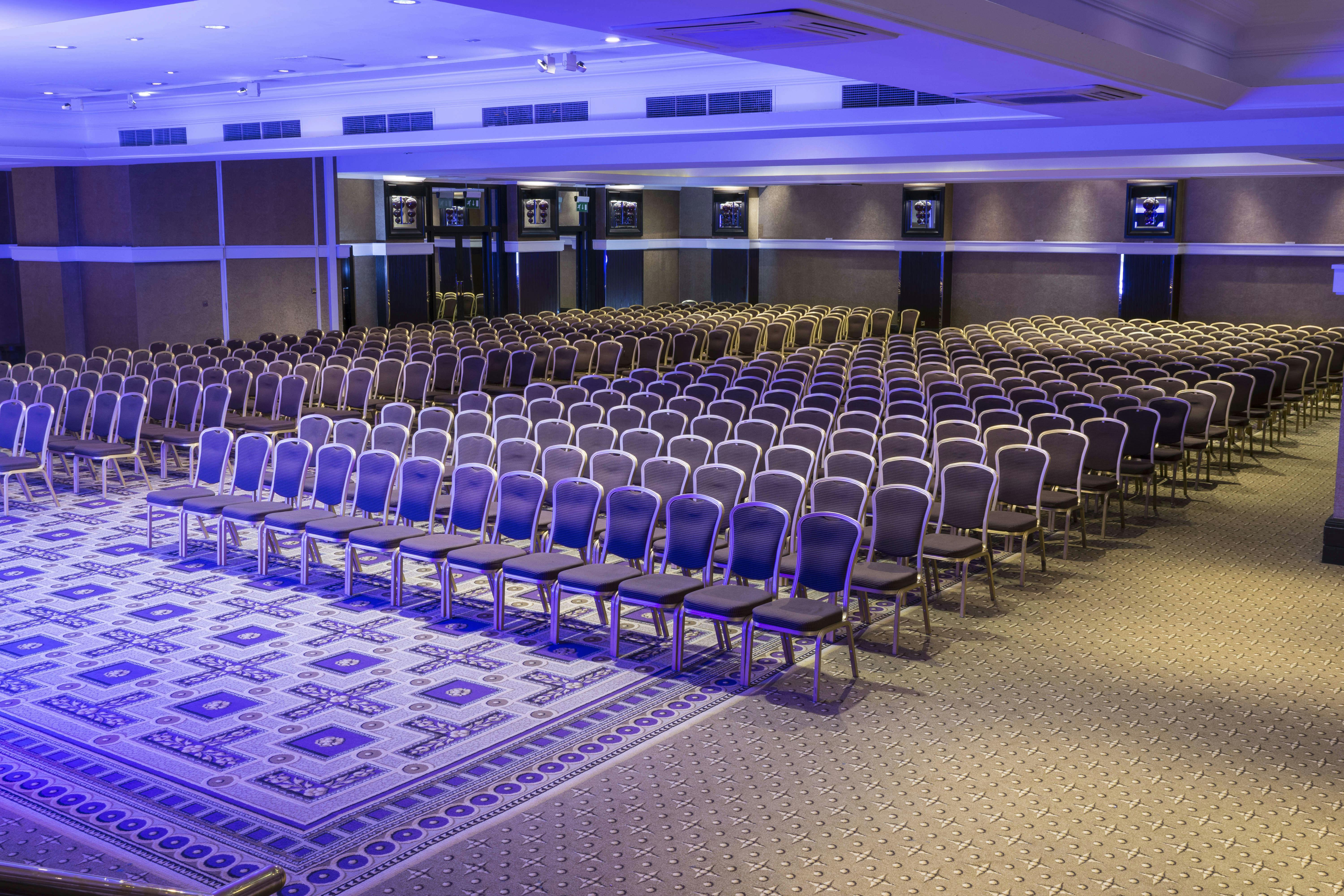 Alexandra Suite at The Midland Hotel, elegant conference venue with arranged chairs.