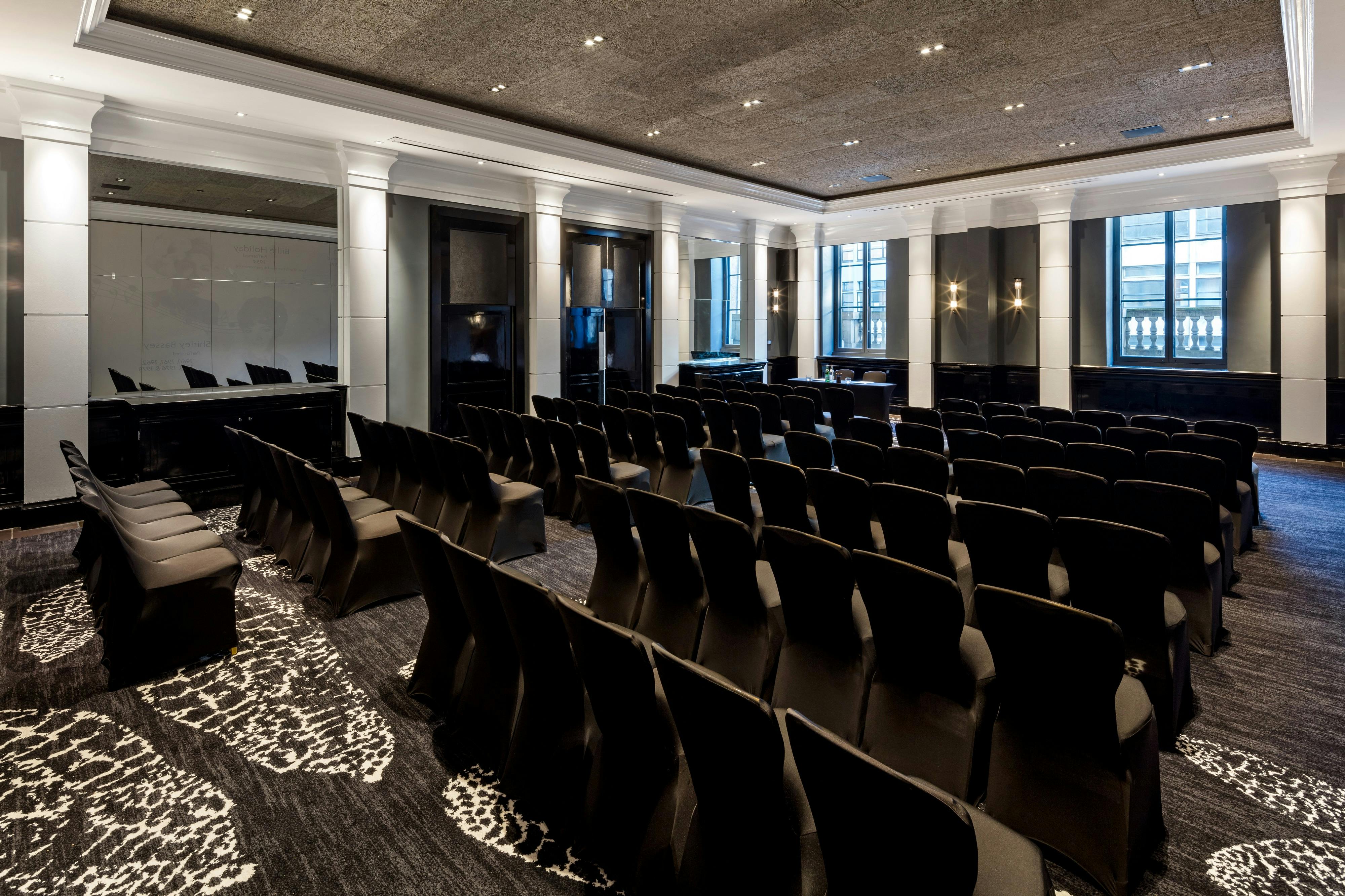 Modern meeting room with black chairs for corporate events at The Edwardian Manchester.