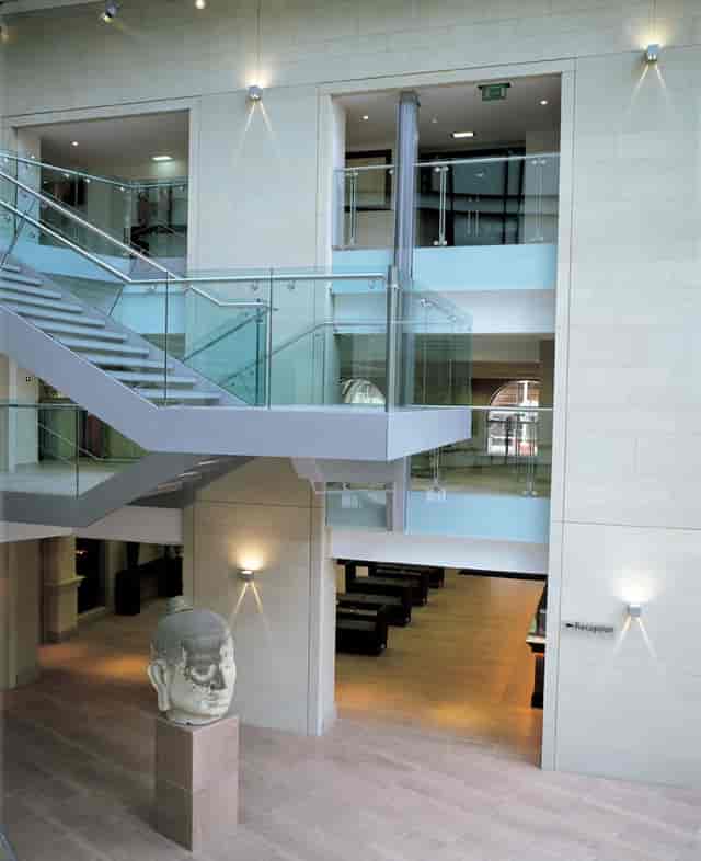 Modern atrium venue with glass railings for networking events in Edwardian Manchester.