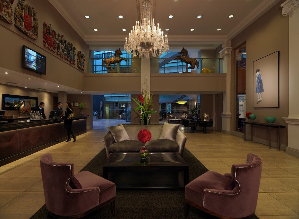 Elegant hotel lobby with chandelier, perfect for meetings and events in Manchester.