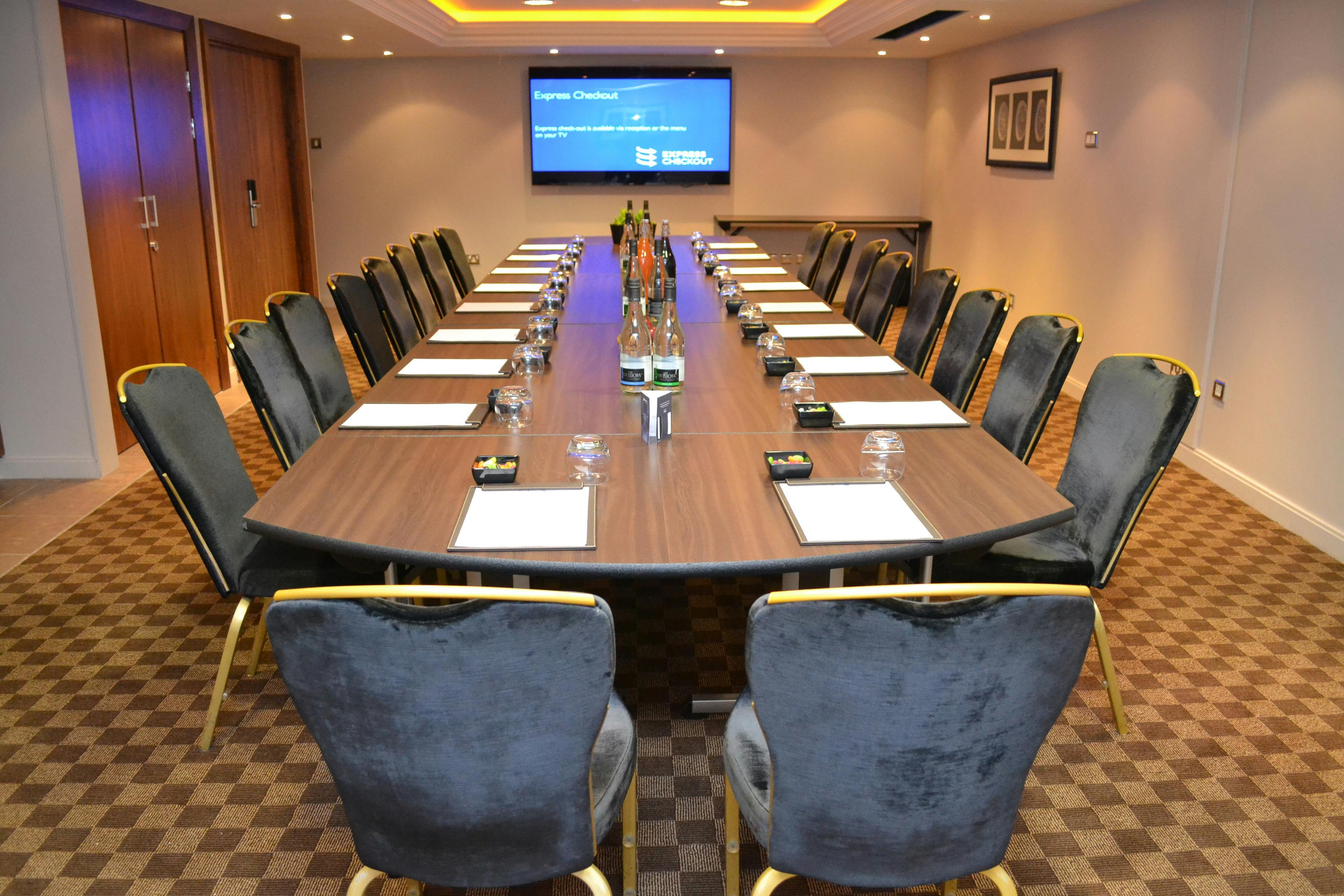 Elegant meeting room with long table, perfect for corporate events and workshops.