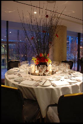 Elegant round table with floral centerpiece for formal dinner or gala event.