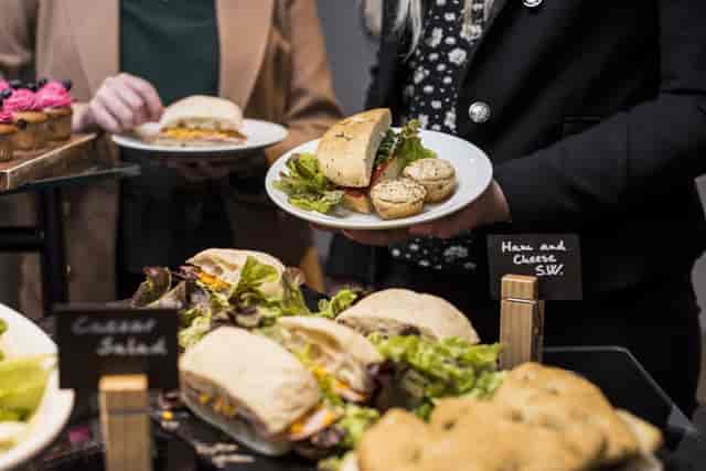 Buffet setup with sandwiches and salads for corporate event at Aloft London ExCeL.