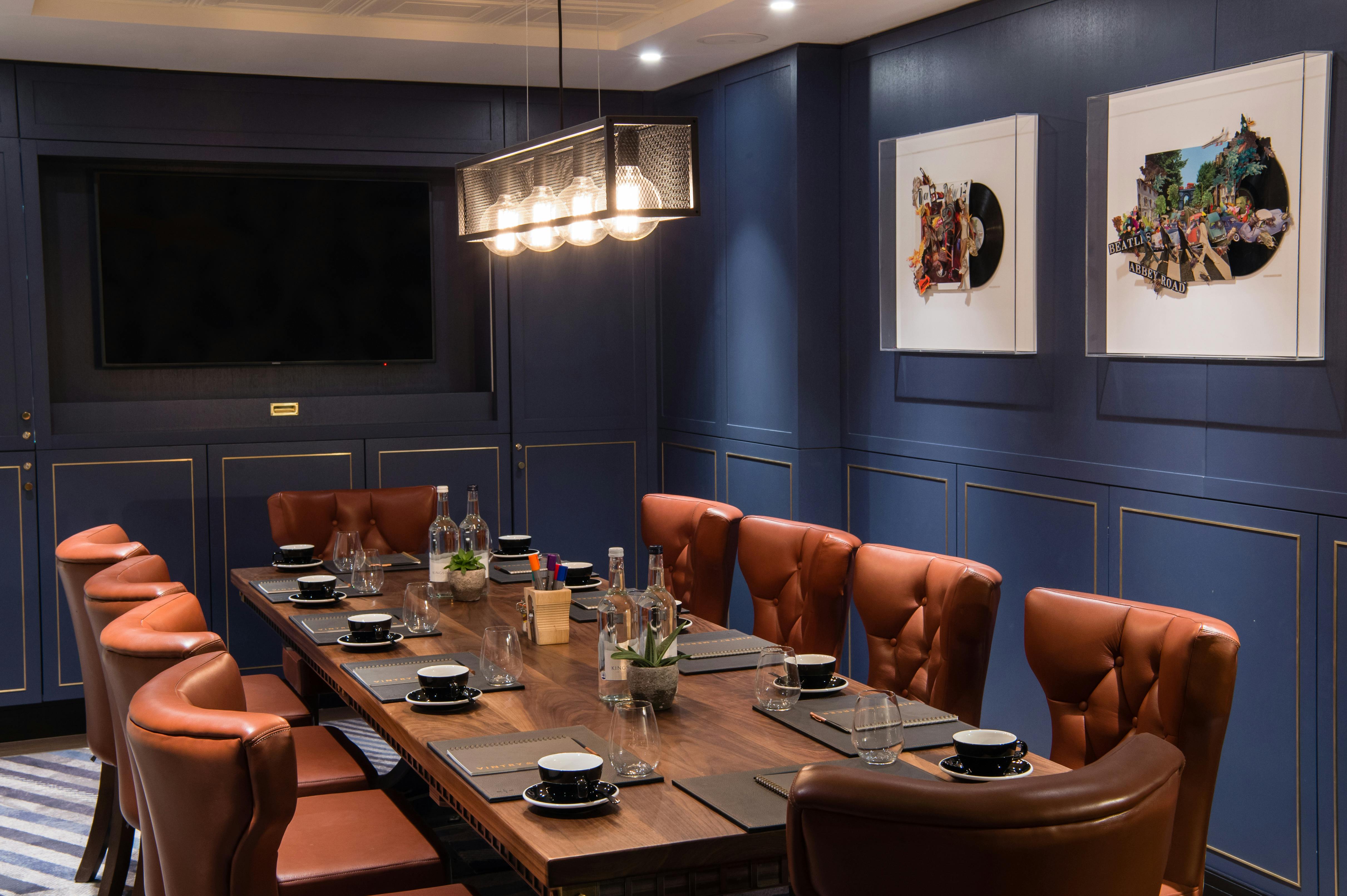 Elegant meeting room with wooden table and leather chairs at Vintry and Mercer Hotel.