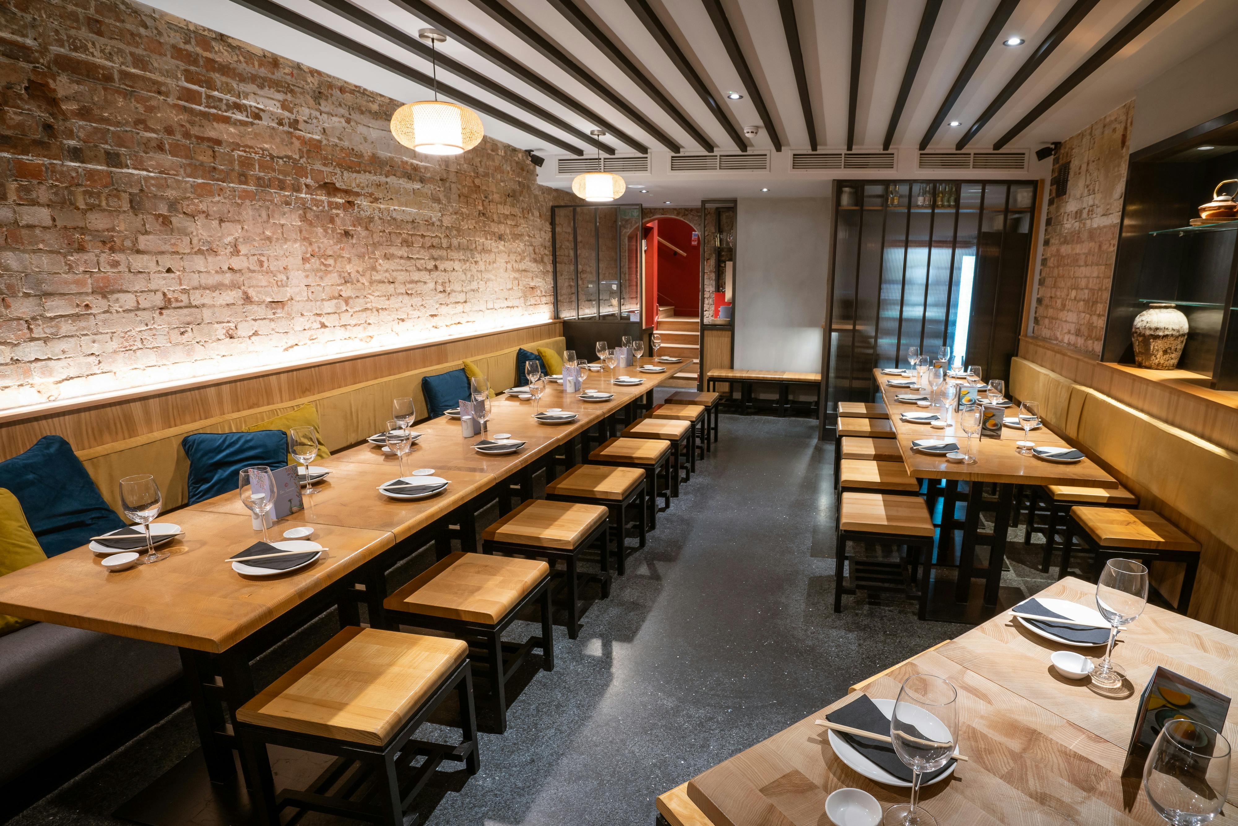 Modern restaurant interior with exposed brick, ideal for group bookings and events.