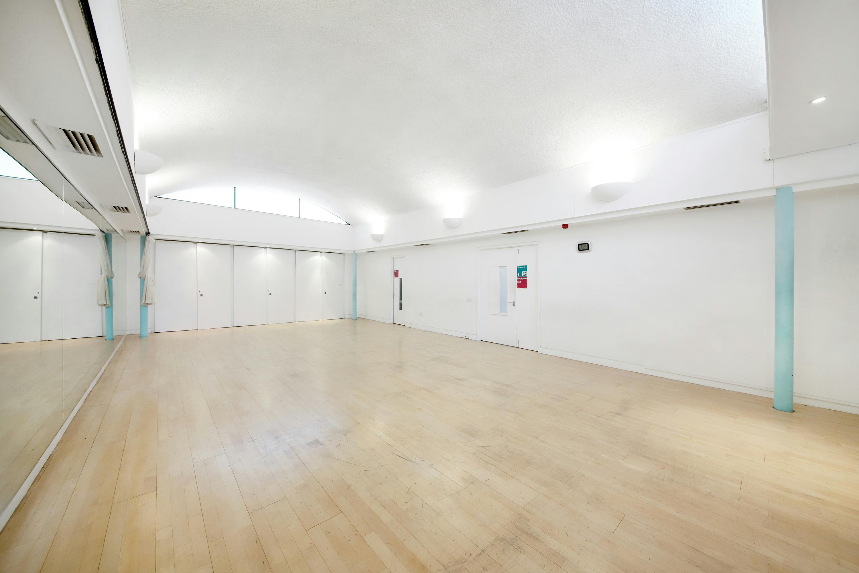 Spacious, well-lit event space with mirrors for workshops and fitness classes.