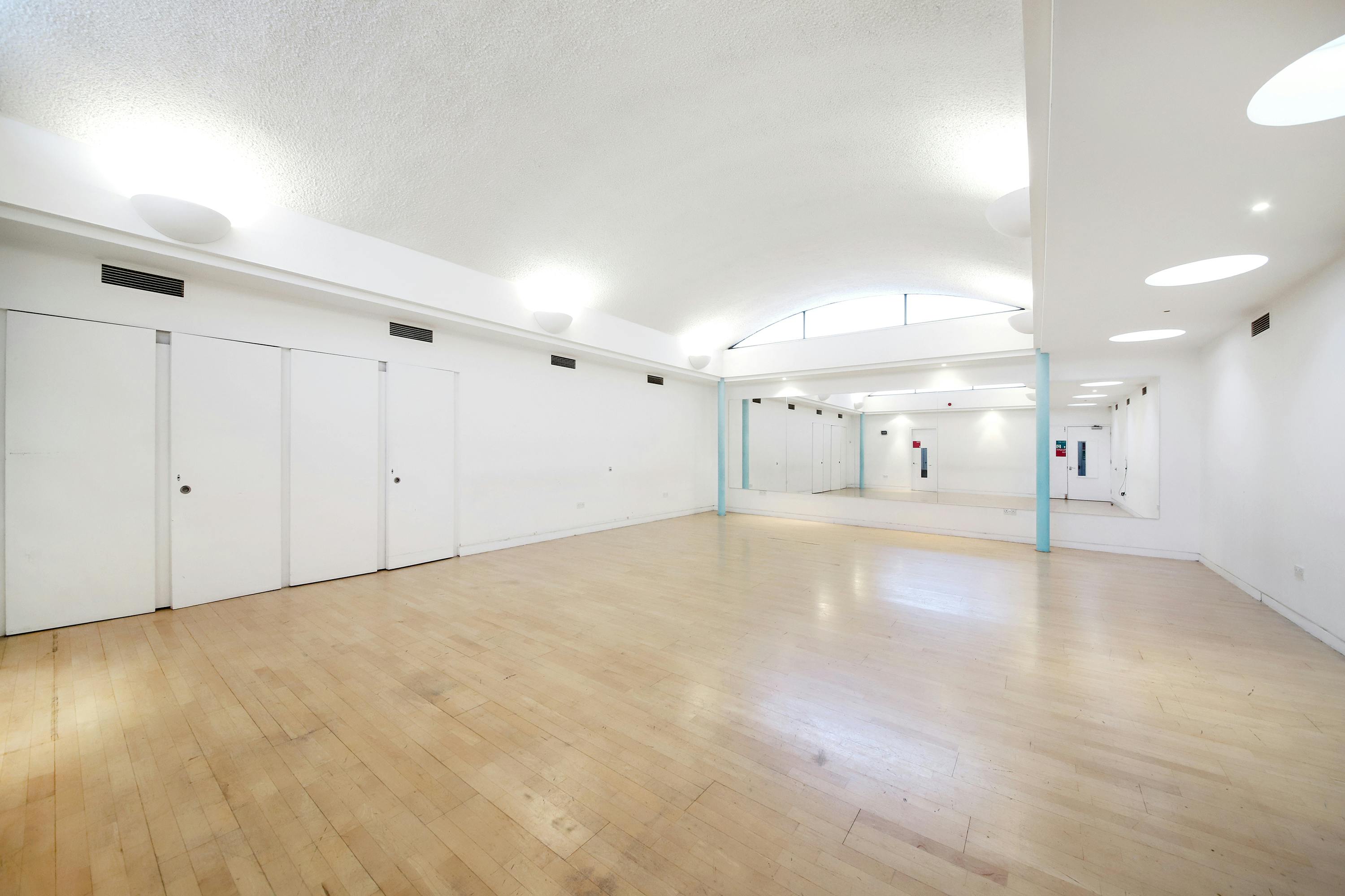 Spacious, well-lit event venue with minimalist design for workshops and gatherings.