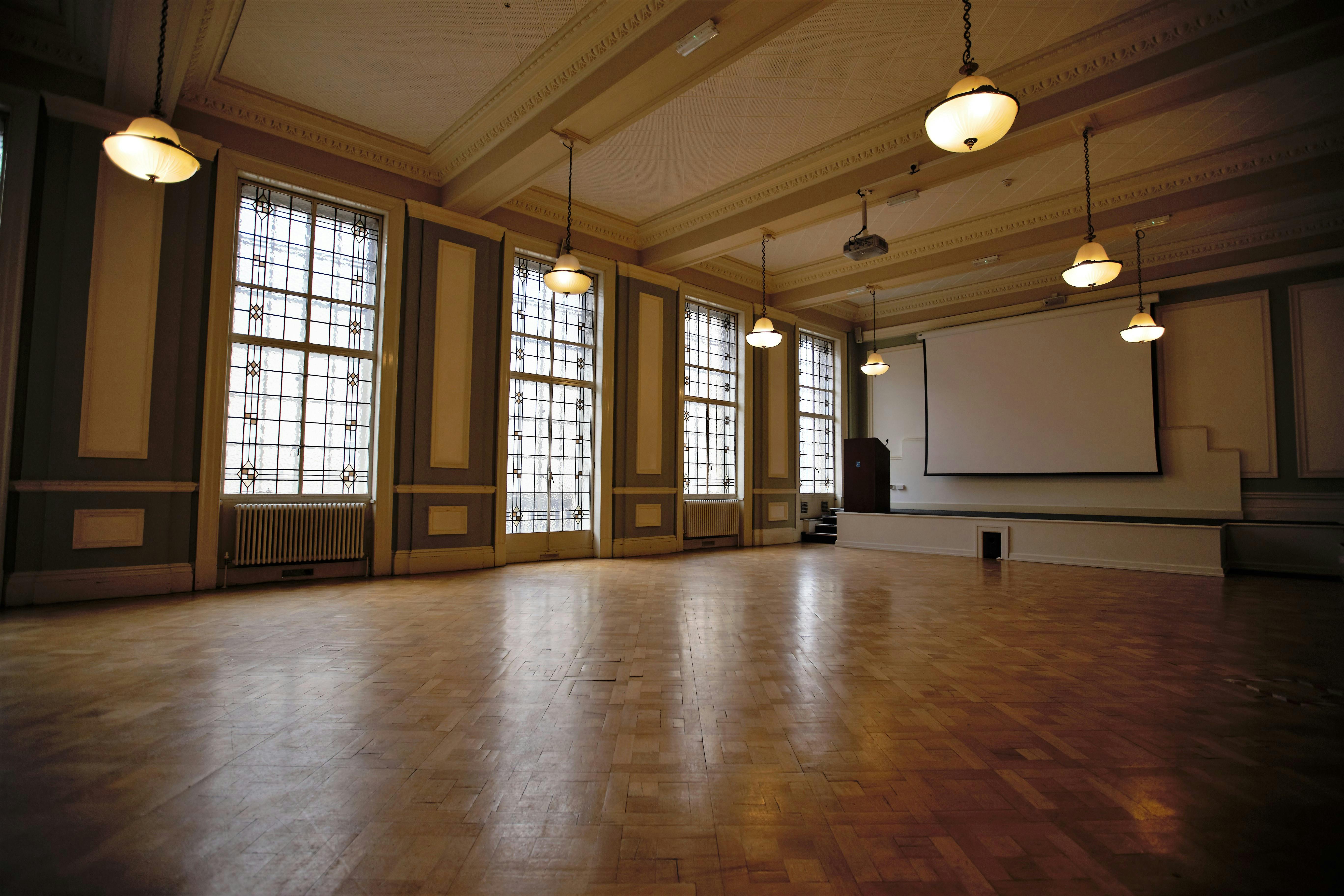 Spacious Chamber Hall with large windows, perfect for workshops and presentations.