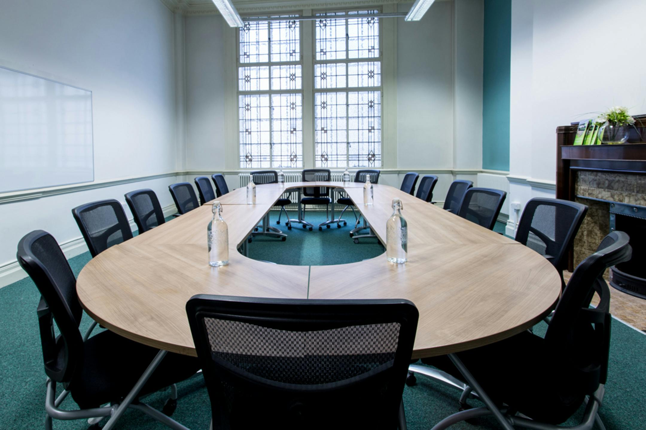 Robertshaw Room at Aspire Igen: oval table, natural light, ideal for meetings and workshops.