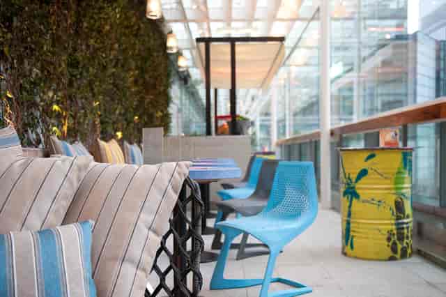 Stylish outdoor bar hire with vibrant decor, ideal for networking events and meetings.