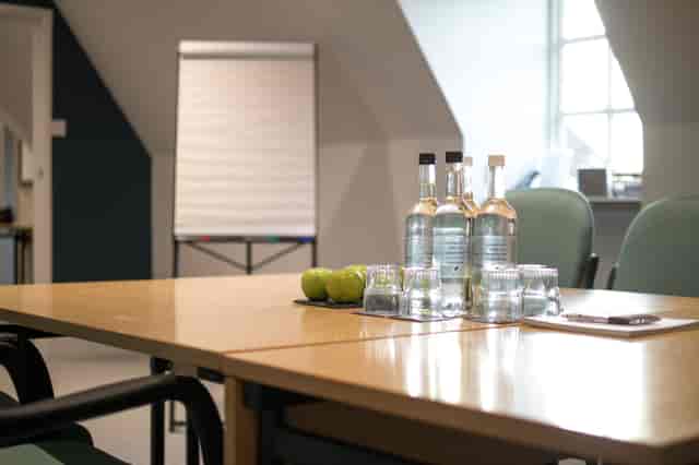 Albury meeting space at Barnett Hill Hotel with clean table setup and flip chart.