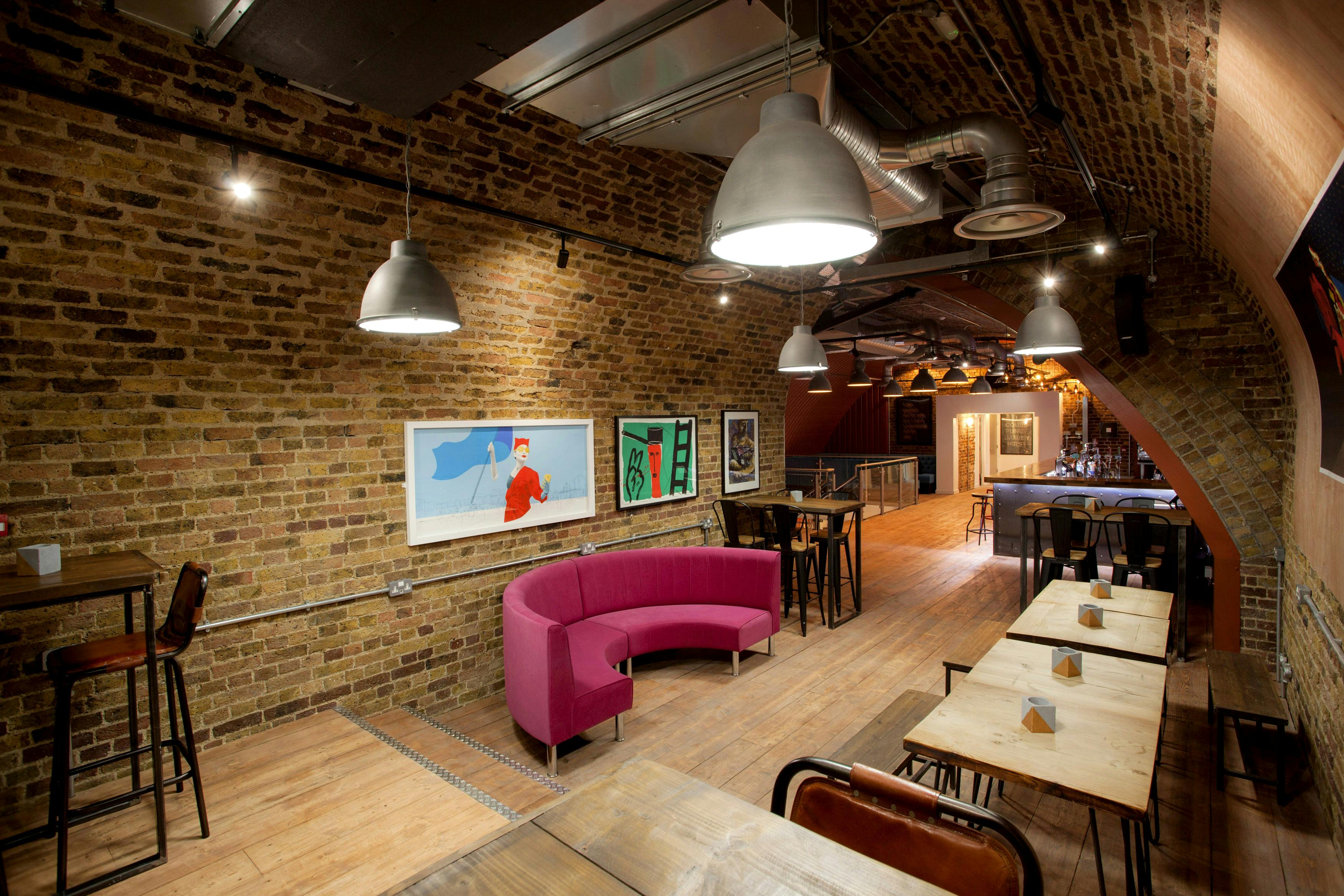 Stylish Upper Arch event space with exposed brick, perfect for networking and meetings.