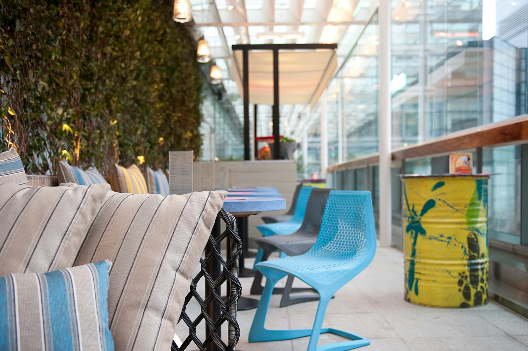 Stylish outdoor bar area with modern seating for casual meetings and networking events.
