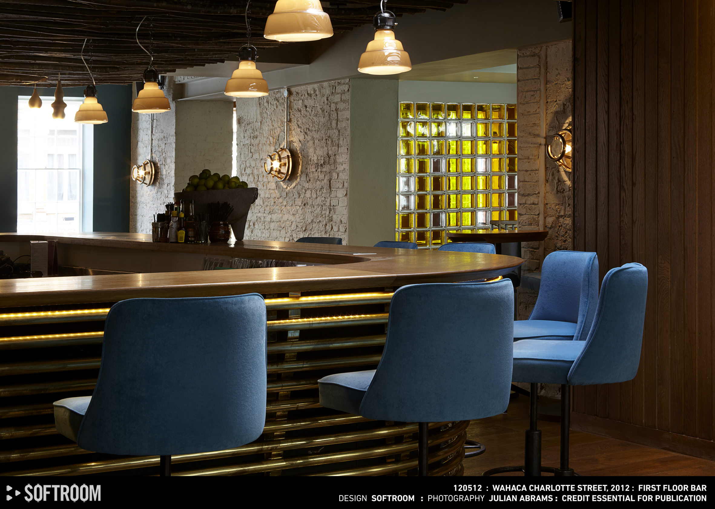 Stylish Mezcaleria Bar venue with blue chairs, ideal for networking events and casual meetings. - Banner