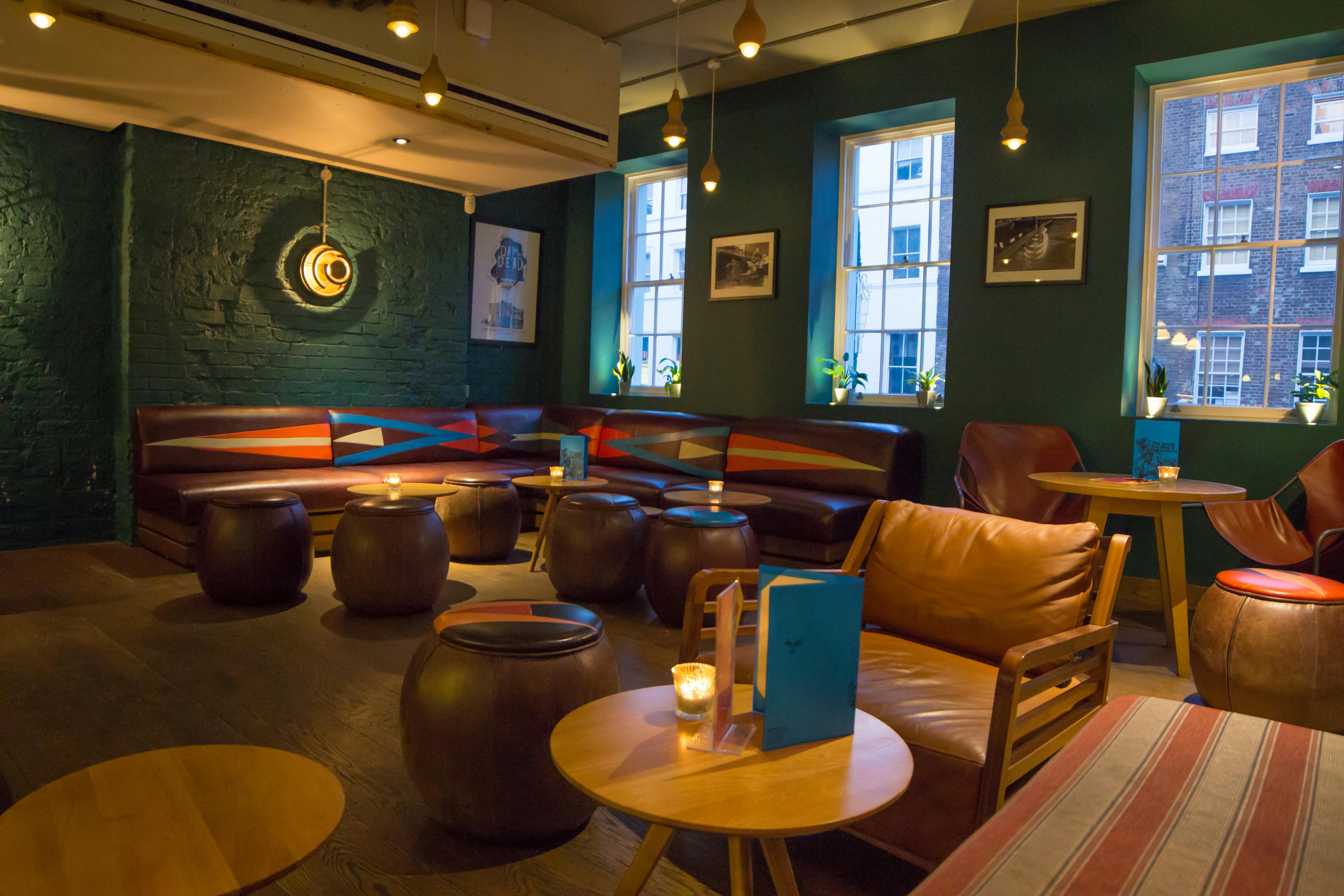 Cozy lounge in Mezcaleria Bar, ideal for networking events and informal meetings.