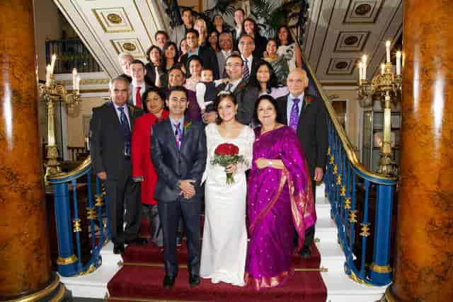 Wedding group photo in Liverpool Town Hall's elegant Main Ballroom, showcasing decor and inclusivity.