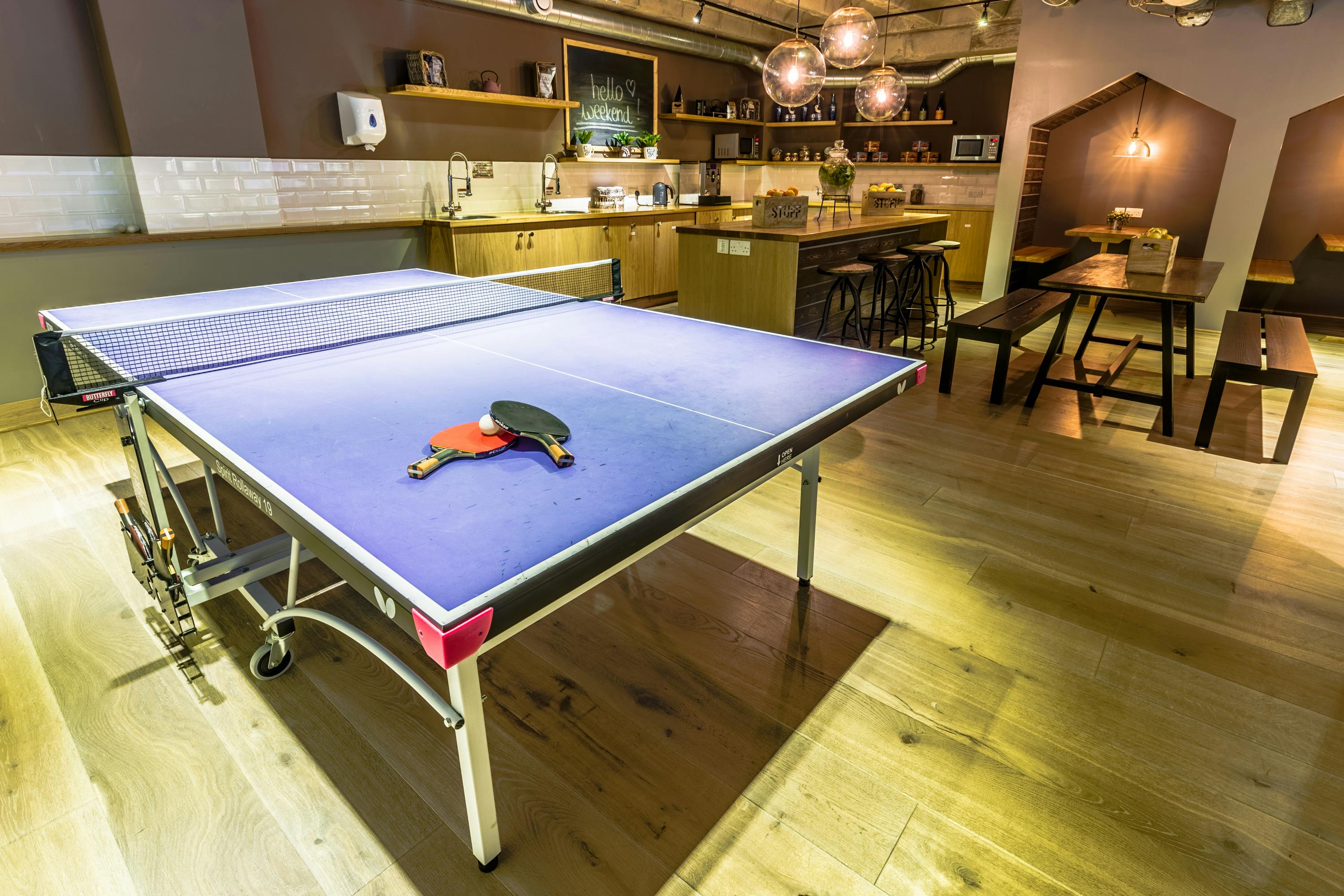 Modern cafe venue with ping pong table for team-building events and networking.