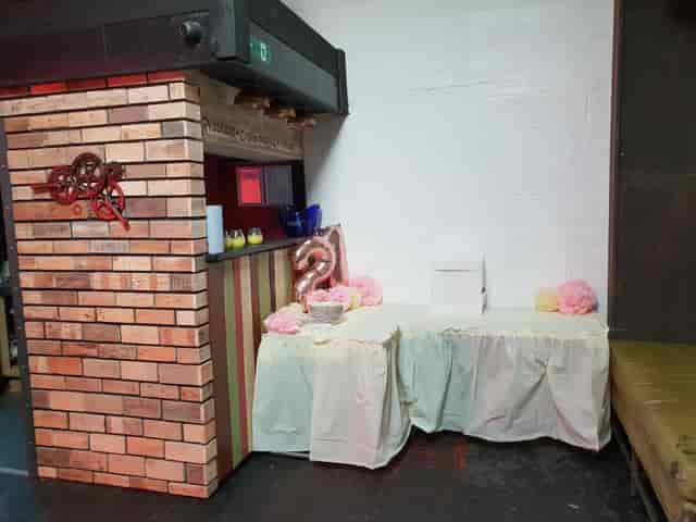 Cozy event setup at The Engine Room Digbeth with rustic bar and pastel decor.
