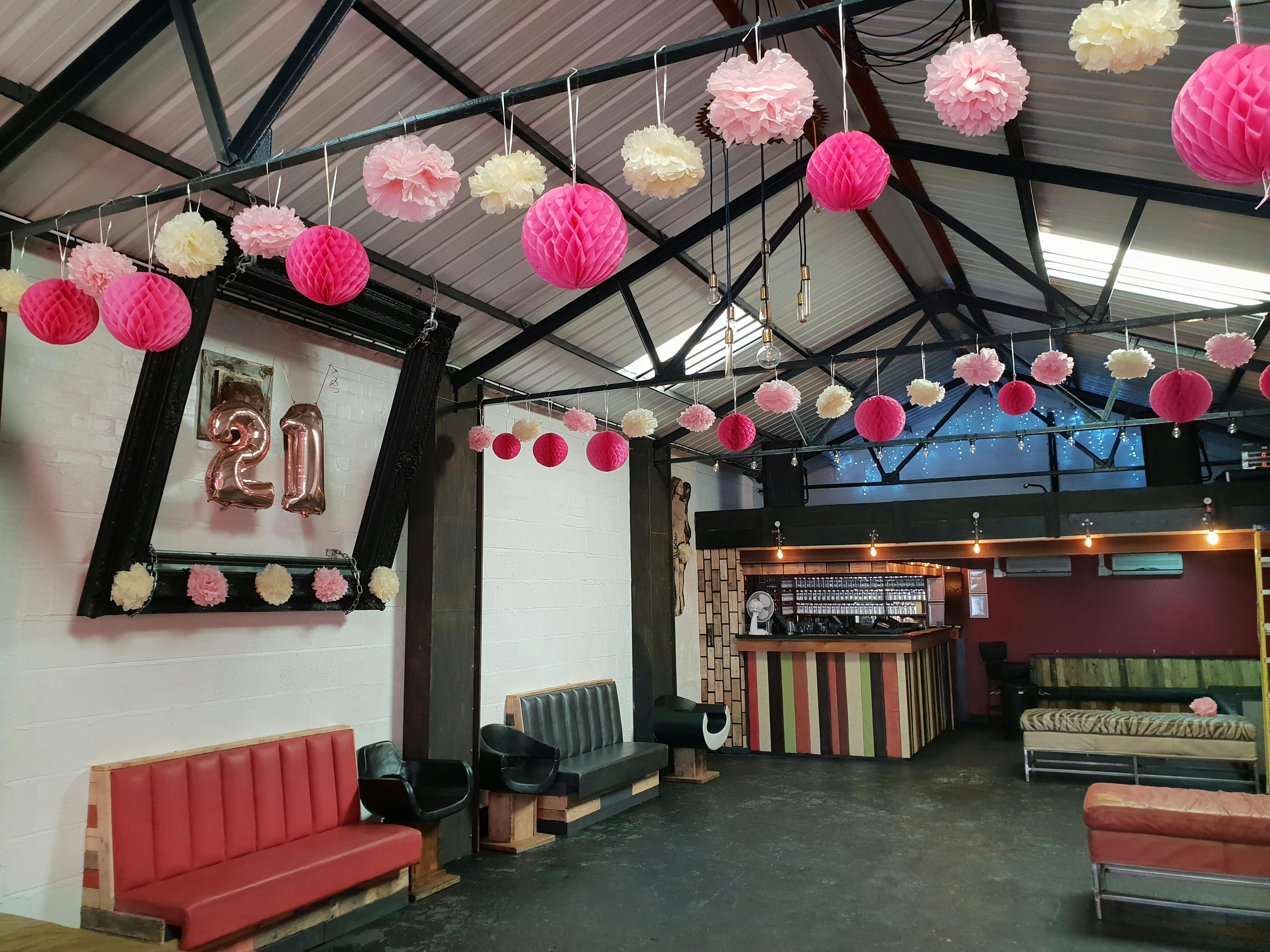 Event space in The Engine Room Digbeth, decorated with pink pom-poms for celebrations.