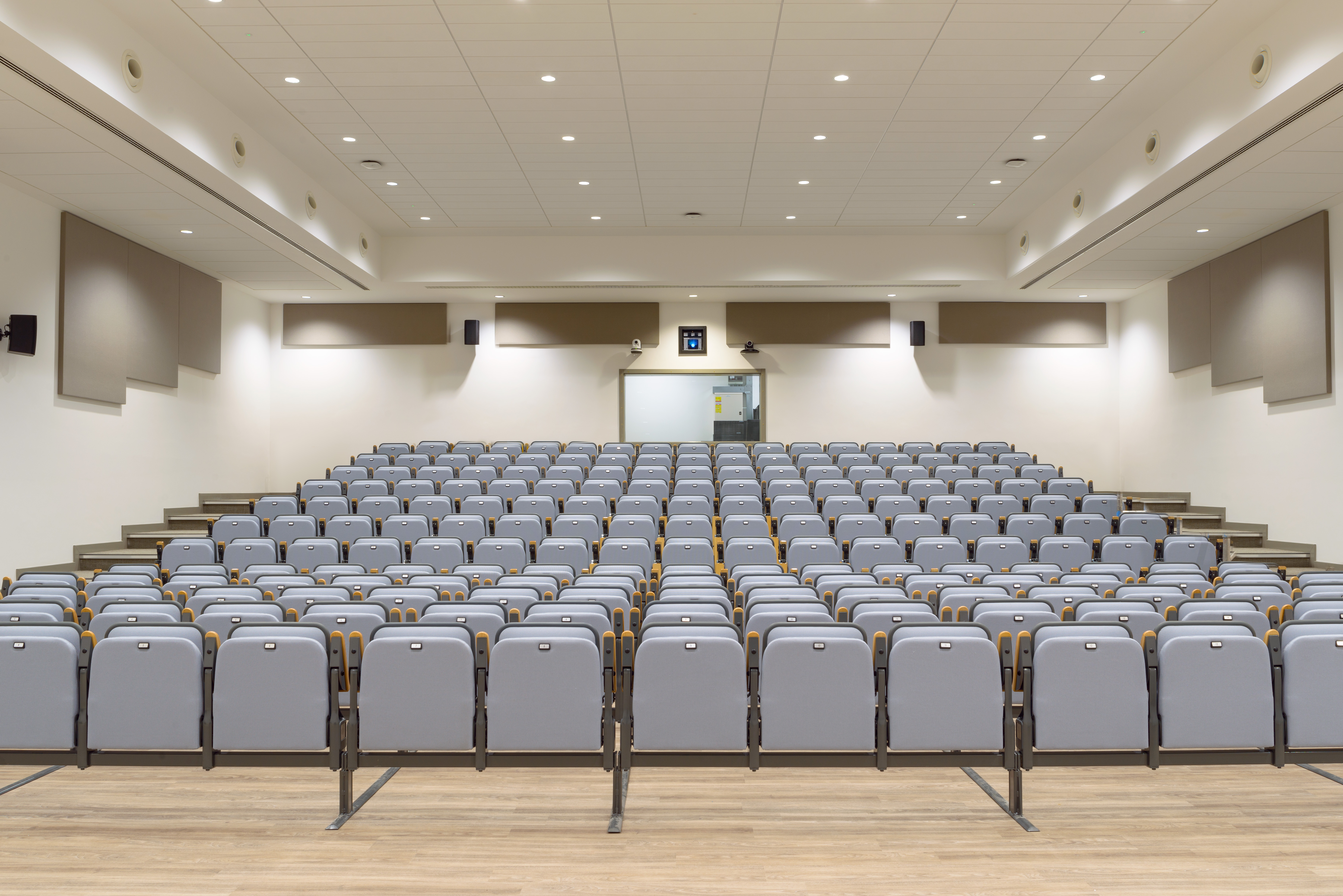 Petersfield Lecture Theatre: spacious auditorium with tiered seating for conferences and presentations. - Banner