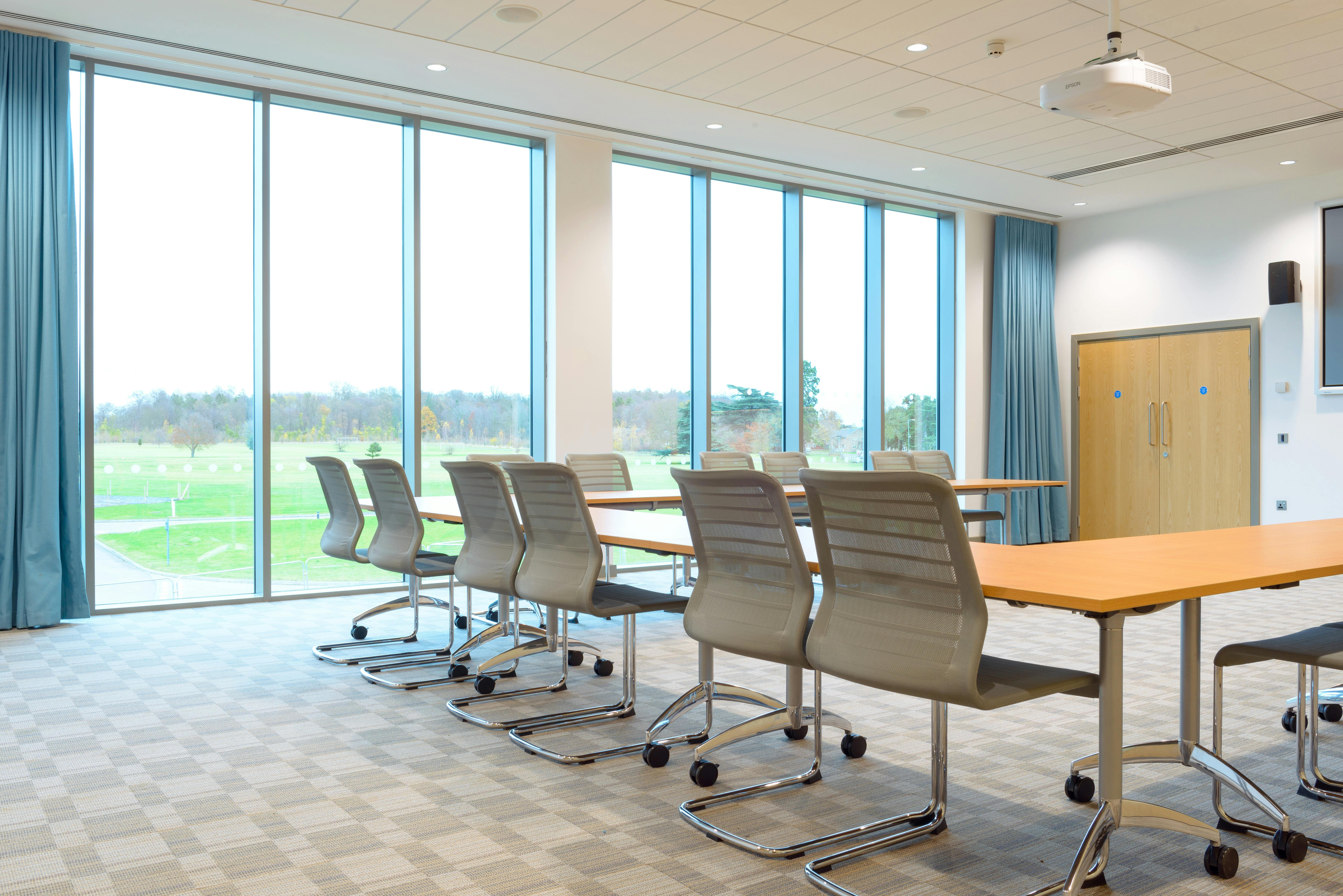 Modern meeting room in King's Hedges, Cambridge, with large windows for workshops.